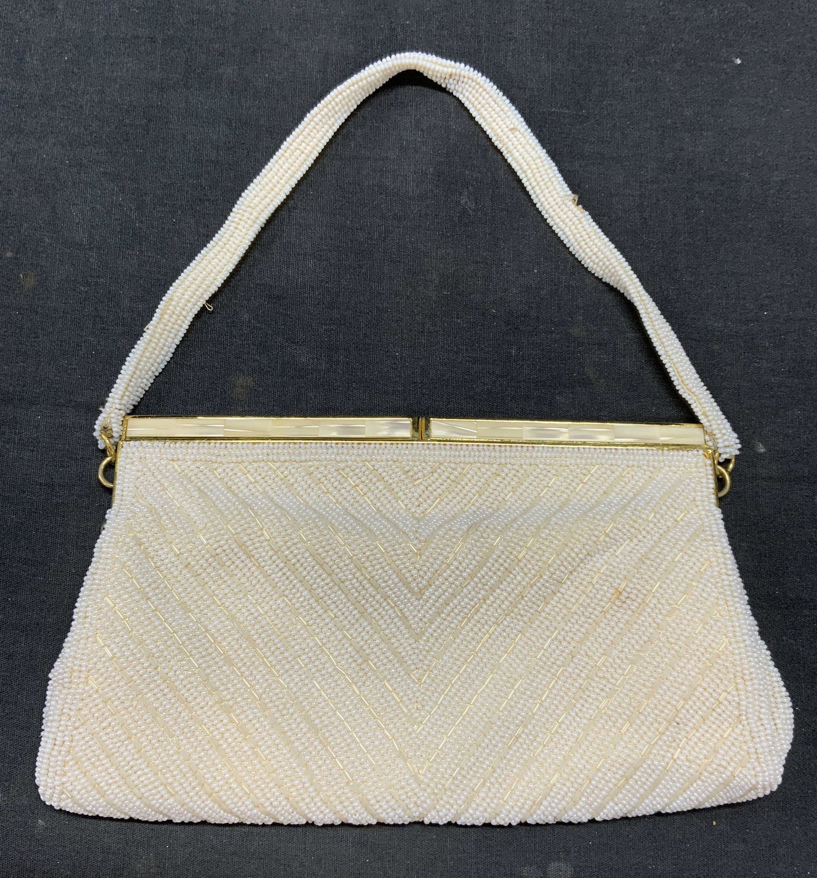 Vintage White Beaded Evening Bag: Vintage white beaded evening bag with gold tone mother of pearl style hardware. Measures approx. 5 x 8 inches. Some wear to material including blemishes and loss to beading observed. Ladies handbag, l
