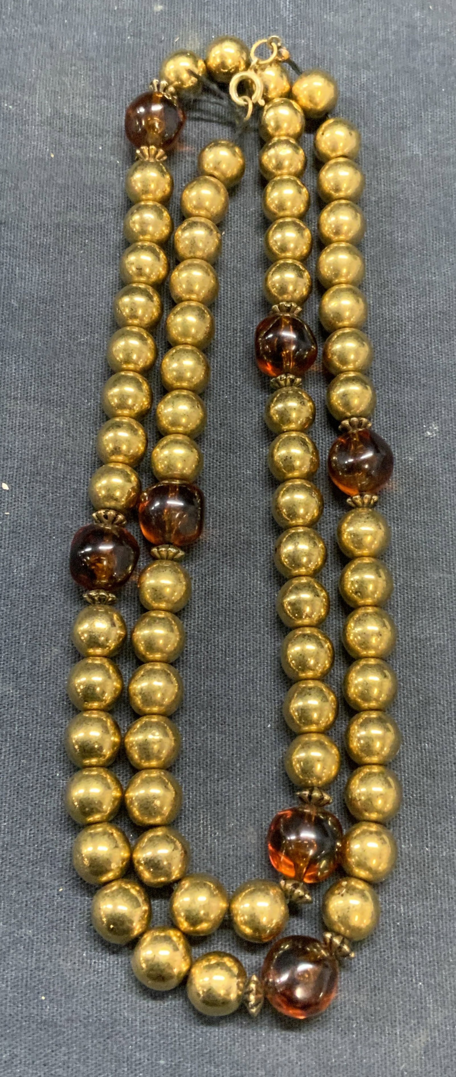 Vintage Gold Tone Beaded Necklace: Vintage gold tone and amber style beaded necklace. Drop length approx. 14 inches. Some surface wear including scratching observed. Estate jewelry, costume jewelry, fashion jewelry, cocktail jewelry, a