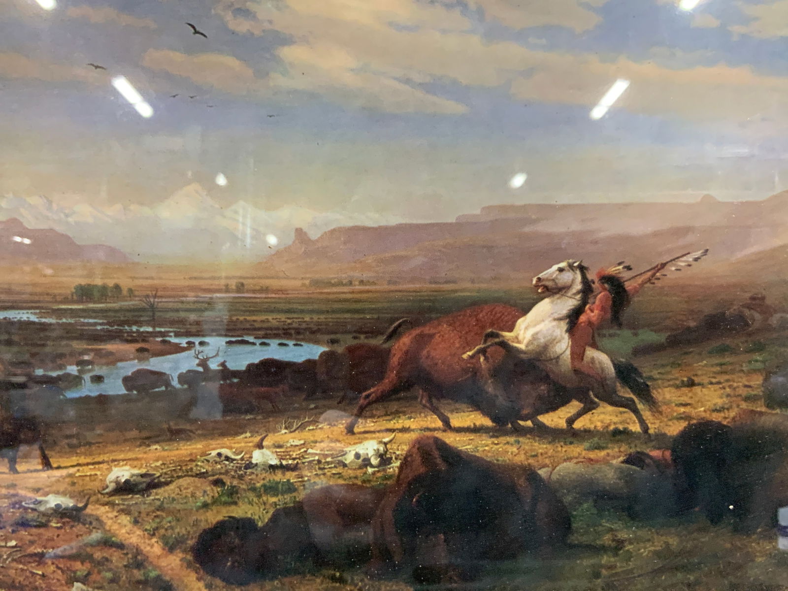 Albert Bierstadt The Last Of The Buffalo Litho: Marked on lower left corner The last of the Buffalo, by Albert Bierstadt. Depicts a group of Native Americans hunting Buffalo against a vast field. Framed in an orange toned wooden frame. Approx 13 x