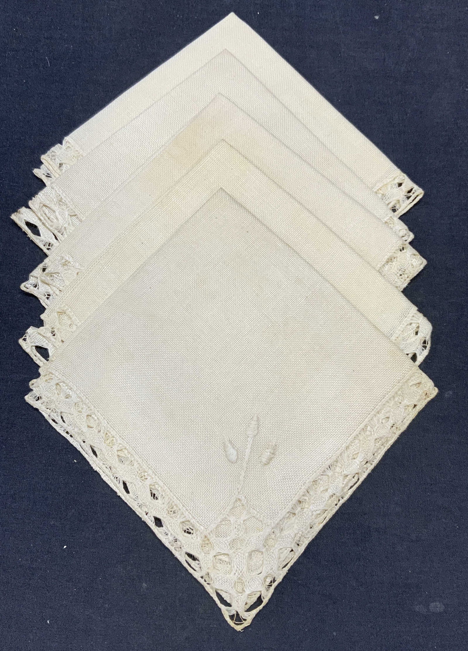Set 5 Vintage Linen Lace Napkins: Set of 5 vintage cream toned napkins with lace trim and embroidered detail. Material feels like linen. Measure approx. 14 x 13 inches each. All pieces have some wear to material and blemishes observed