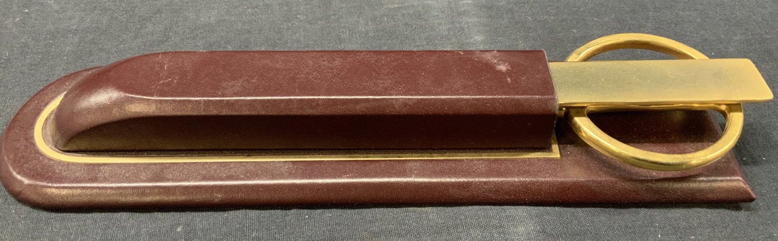 Dacasso MCM Letter Opener W Leather Case: Marked Dacasso on underside, Mid century modern letter opener and scissor with leather made case in a red toned leather. Letter opener and scissor handles are adorn in a gold tones. Case is approx 10 