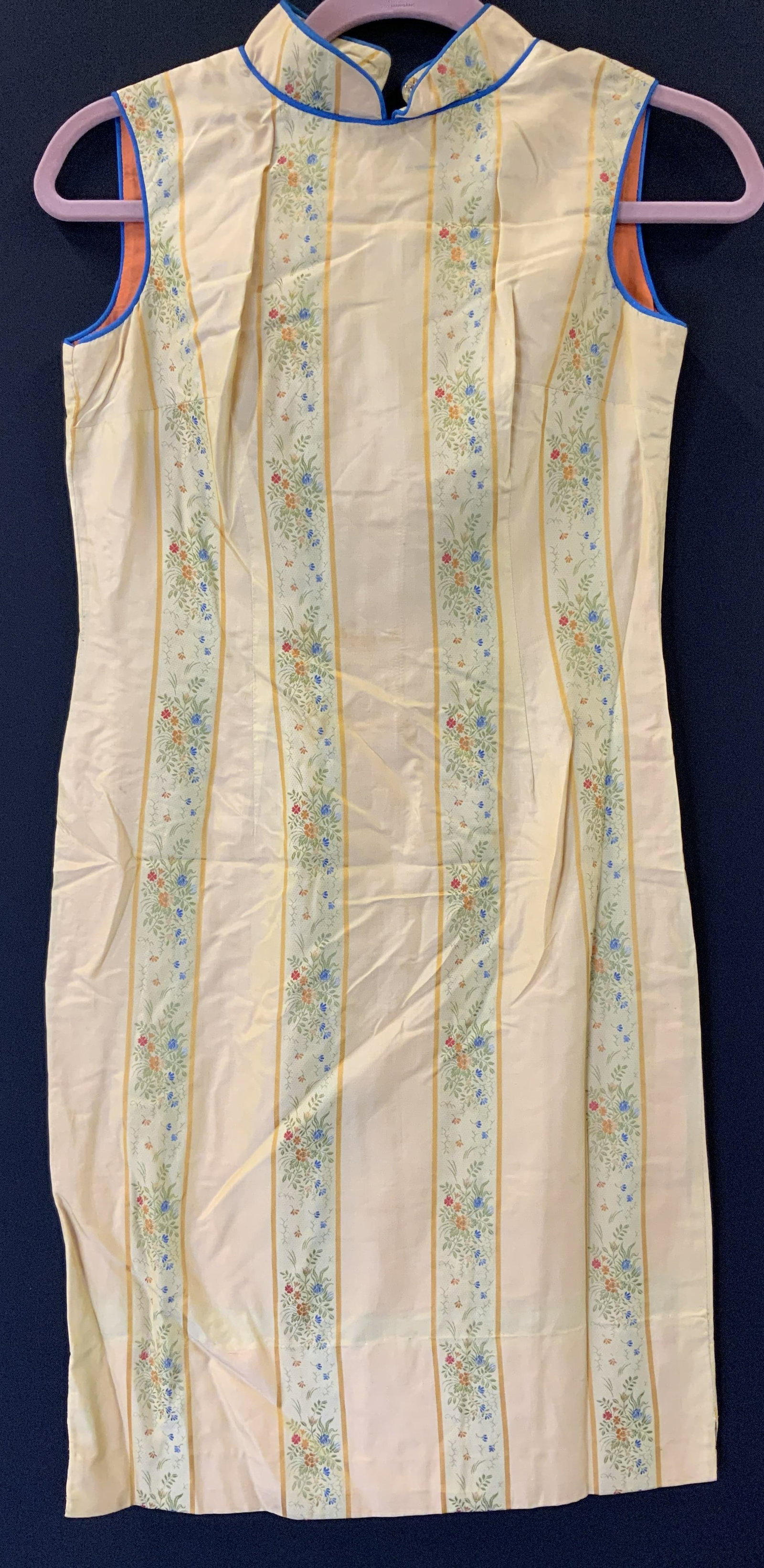 Handmade Vintage Asian Silk Shift Dress: Yellow Asian sleeveless dress with blue piping collar and sleeve hem. Traditional high Asian collar. Backside zipper and neck hooks. Stitched by hand and machine. 35.5 in. Long., waist 28 in. hips 32 