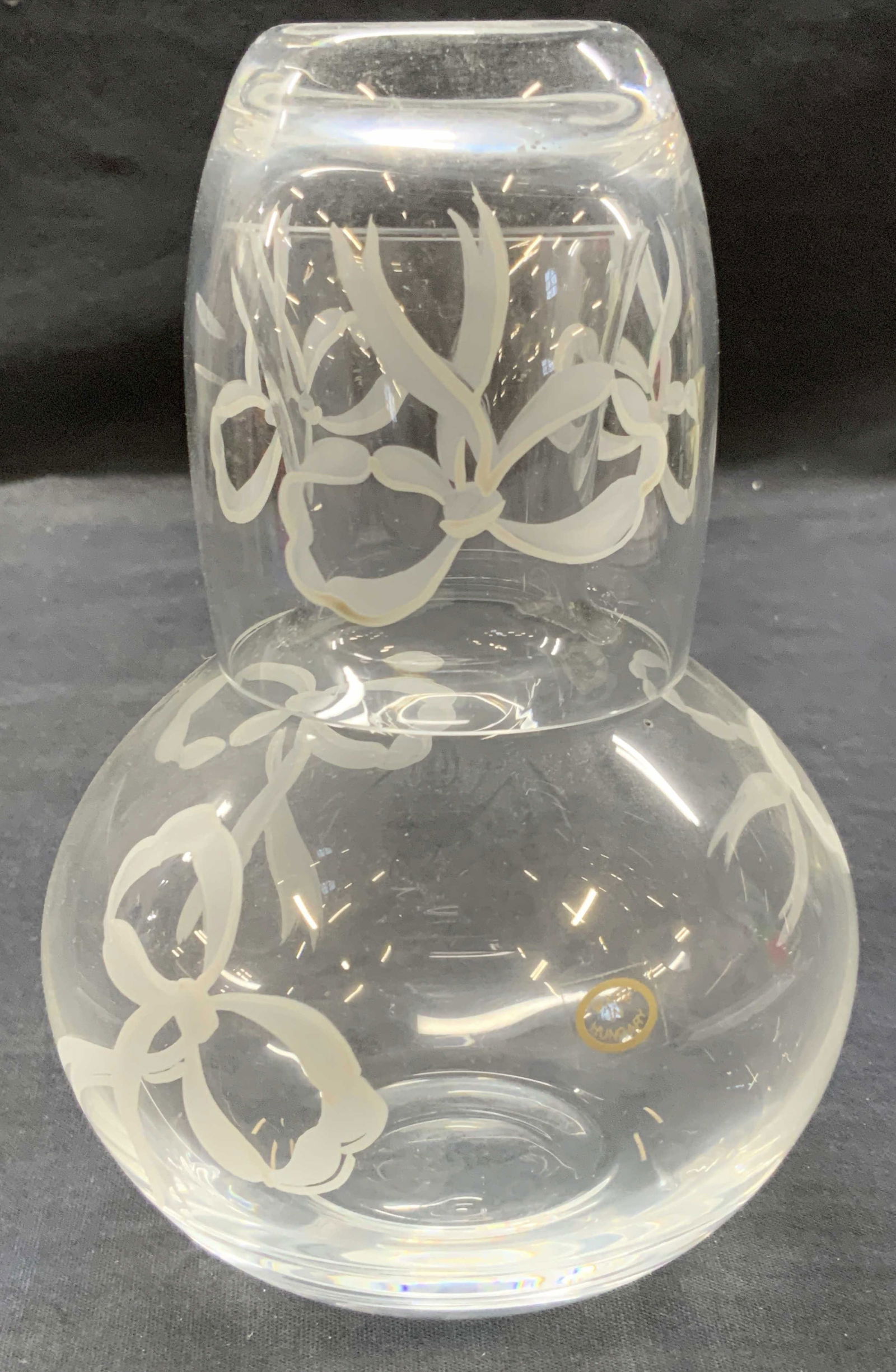 Hand Painted Glass Carafe, Hungary: Clear glass and hand painted carafe with white painted ribbons on decanter and glass. Approximately 7 inches tall and 3.25 inch tall cup and decanter being 6 inches tall. Minor wearing to glass due to