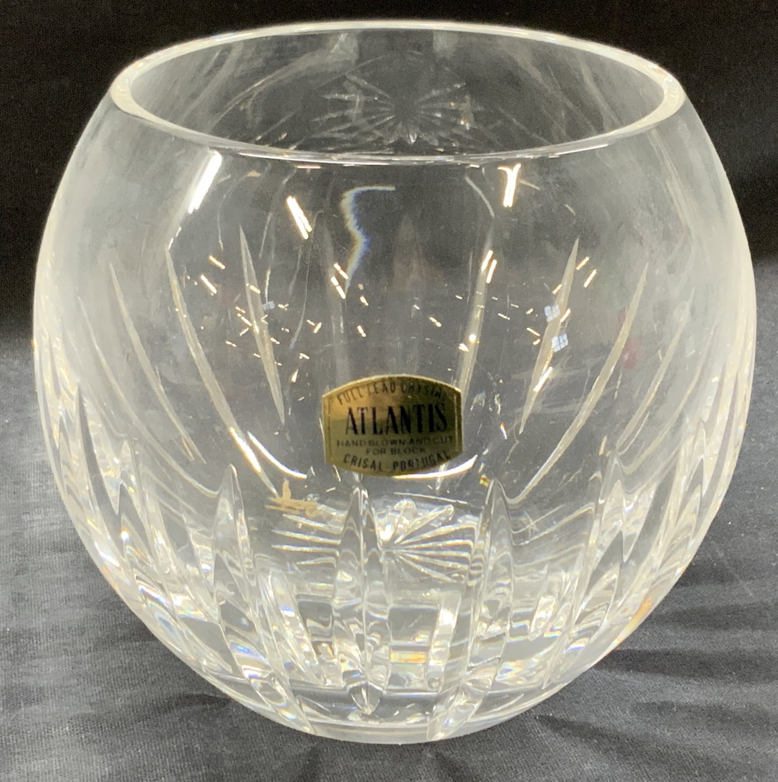 Atlantis Hand Blown Crystal Vase: Marked in sticker. Hand blown and cut Atlantis full lead crystal circular vase with vertical cut grooves on exterior. Approx 4 inches tall and 3.25 inch diameter. Comes in off white cardboard box. App