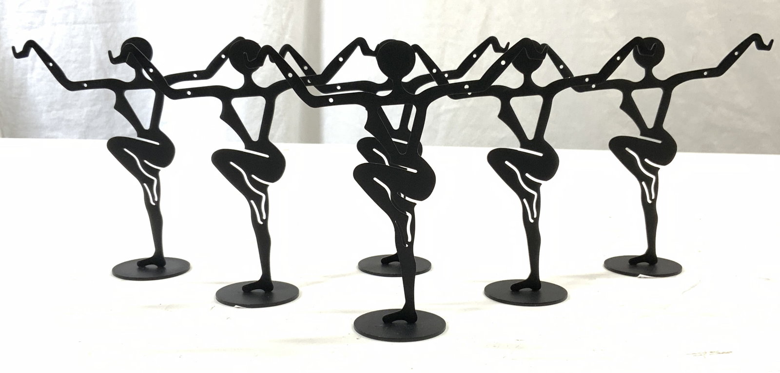 Set 6 Metal Female Dancer Figure Earring Stands: Earring stands are black toned and metal. Each have female dancer form with leg raised and arms out. Each have hooks and holes to hang earrings. Each measures approx 4.75 inches tall & wide 1.5 inches