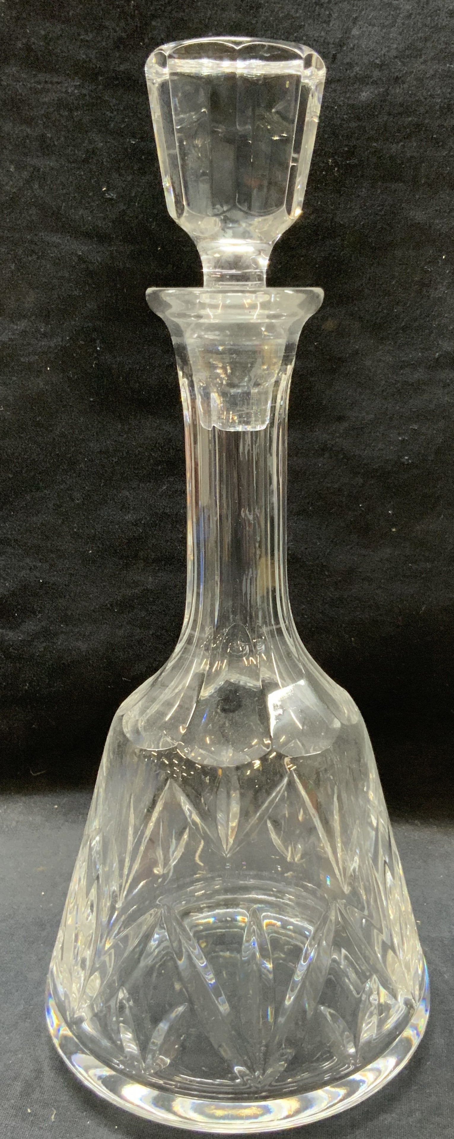 Clear Cut Crystal Decanter: Clear cut crystal decanter with floral style designs in exterior and faceted stopper. Approx 12 inches tall with a 5 inch diameter base. Minor surface wearing to crystal. Home decor, decanter, cut cry