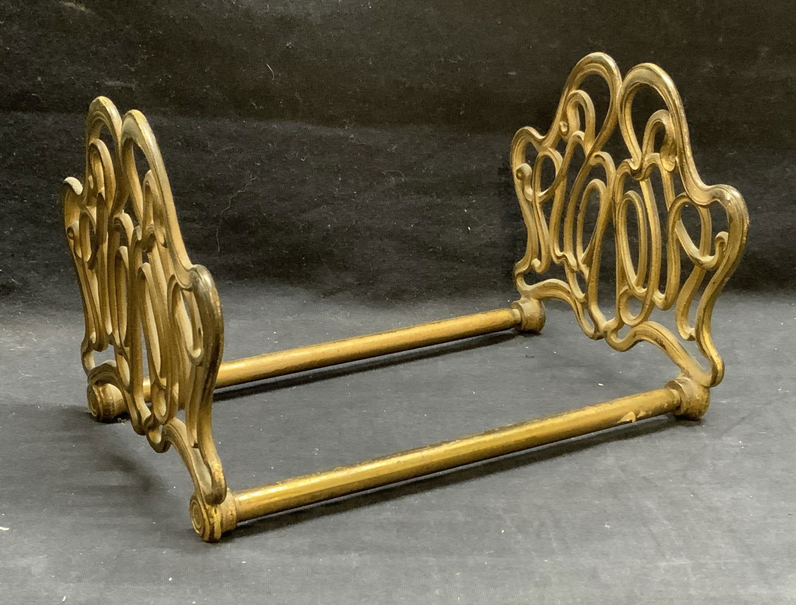Vintage Gilt Scroll Frame Adjustable Bookend: Vintage gilt metal scroll motif adjustable base bookend. Measures approx. 15 x 6.5 x 5.75 inches fully extended. Some surface wear including scratching and loss to gilt observed. Bookend, gilt bookend