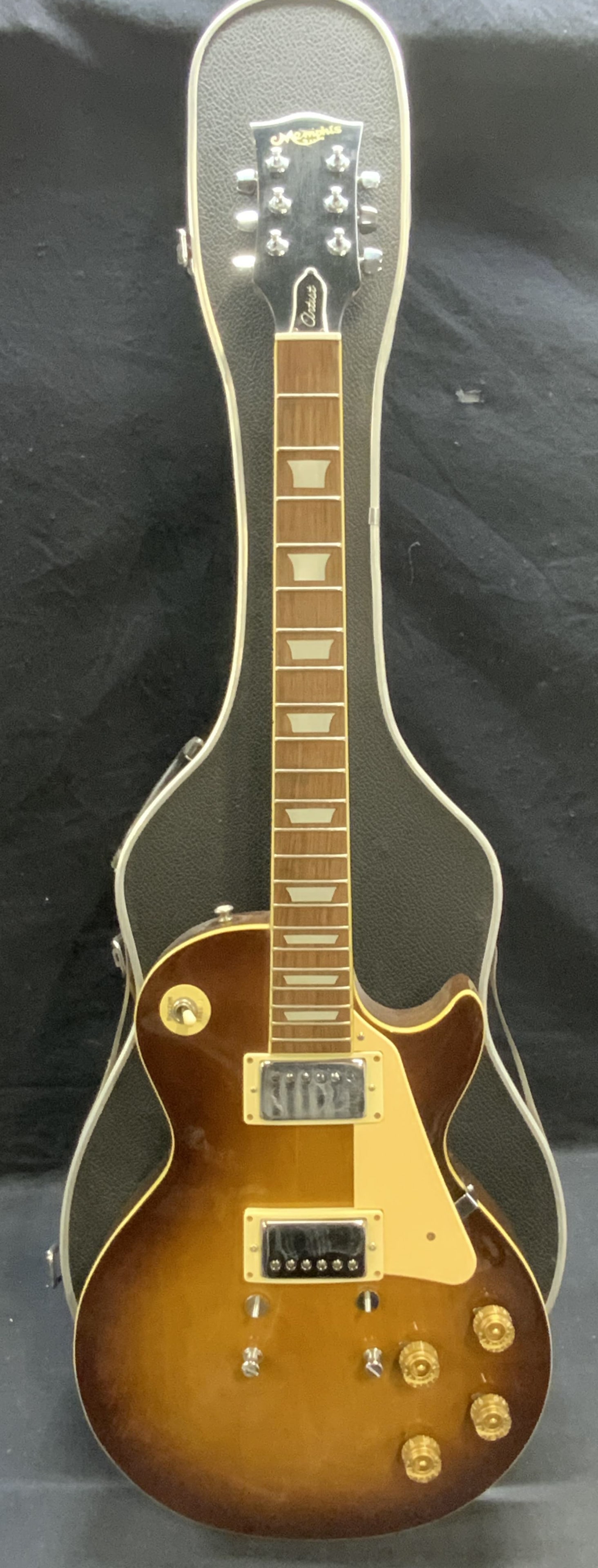 Memphis Artist Wood Guitar & Case: Memphis Artist guitar and case, lacquered natural tone wood. Measures approx. 40 x 12.5 inches. Some surface wear including scratching observed. Not tested for function. Memphis Artist, Memphis Artist