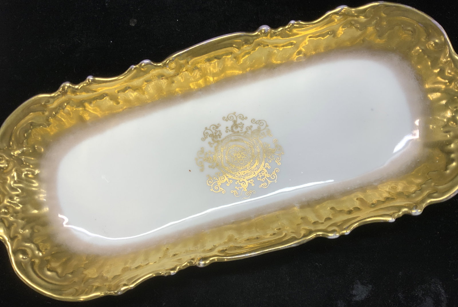 Antique Limoges France Coiffe Gilt Porcelain Dish: Oblong Jeune Coiffe Limoges with pre 1890 green star hallmark under glaze. Wide solid gilt rim on white porcelain with detailed center gilt medallion. Blue Limoges France Hallmark over glaze. Measures