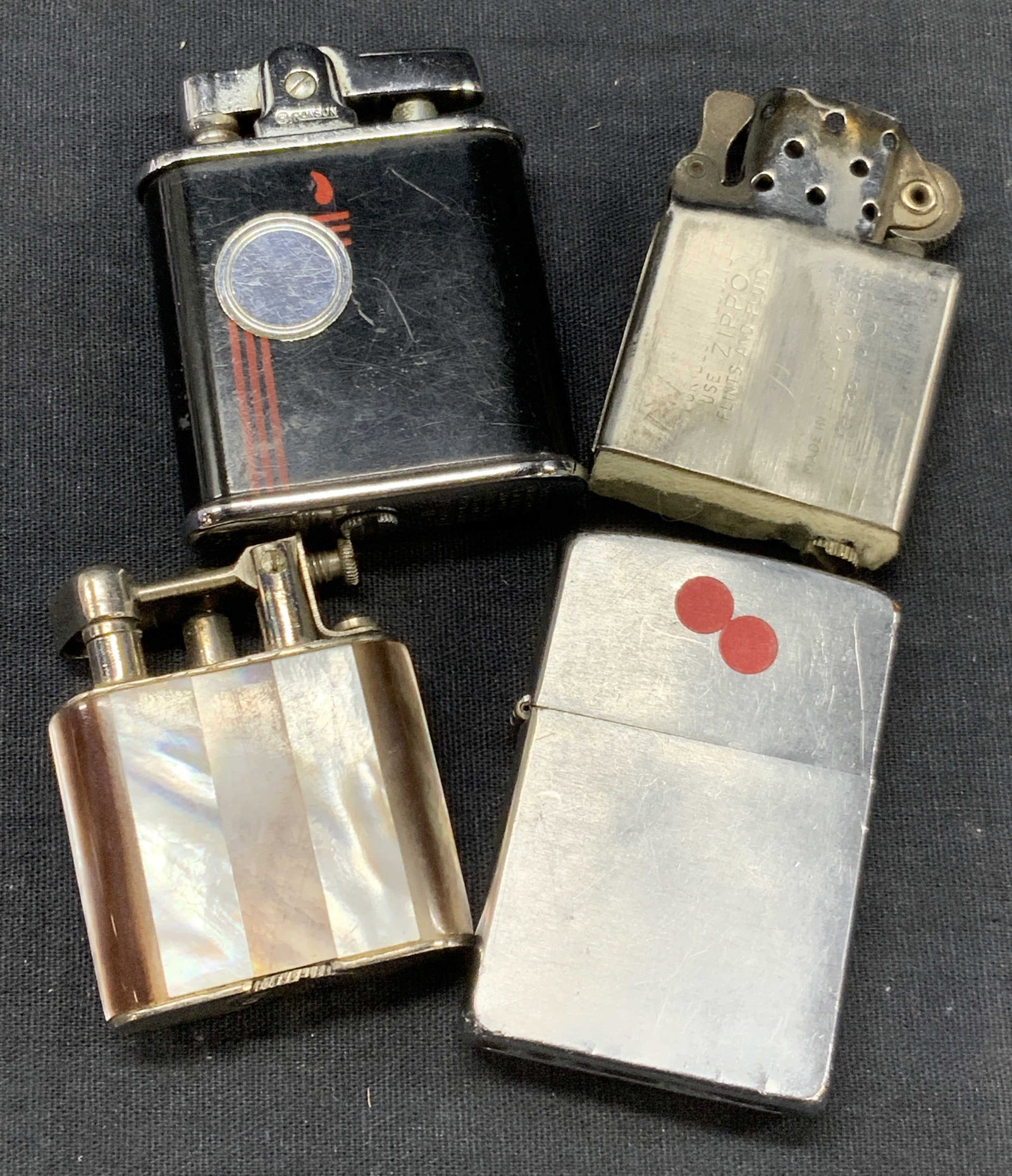 Lot 4 Vtg Lighters Zippo & Ronson: Lot of 4 vintage lighters. 1 zippo with an extra zippo wick insert, 1 lighter in black marked Ronson Vanguard. Approx 2.25 inches tall. And 1 lighter with one side adorn in mother of Pearl. Approx 2 i