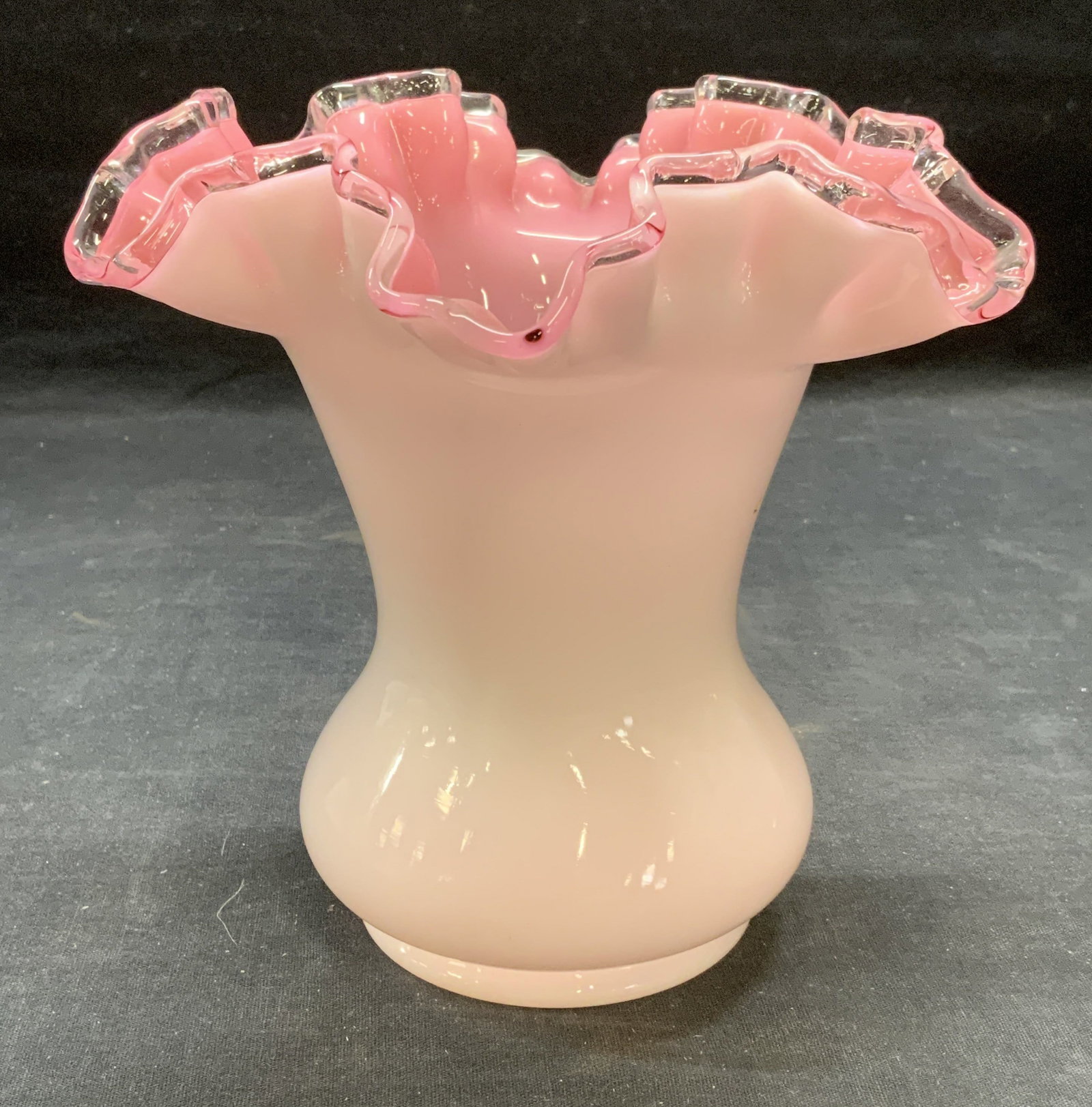 Vintage White & Pink Milk Glass Ruffle Vase: Vintage pink and white toned milk glass vase with ruffle handkerchief rim. Measures approx. 7 x 6.75 inches. Some surface wear including scratching observed. Milk glass, milk glass vase, white vase, p