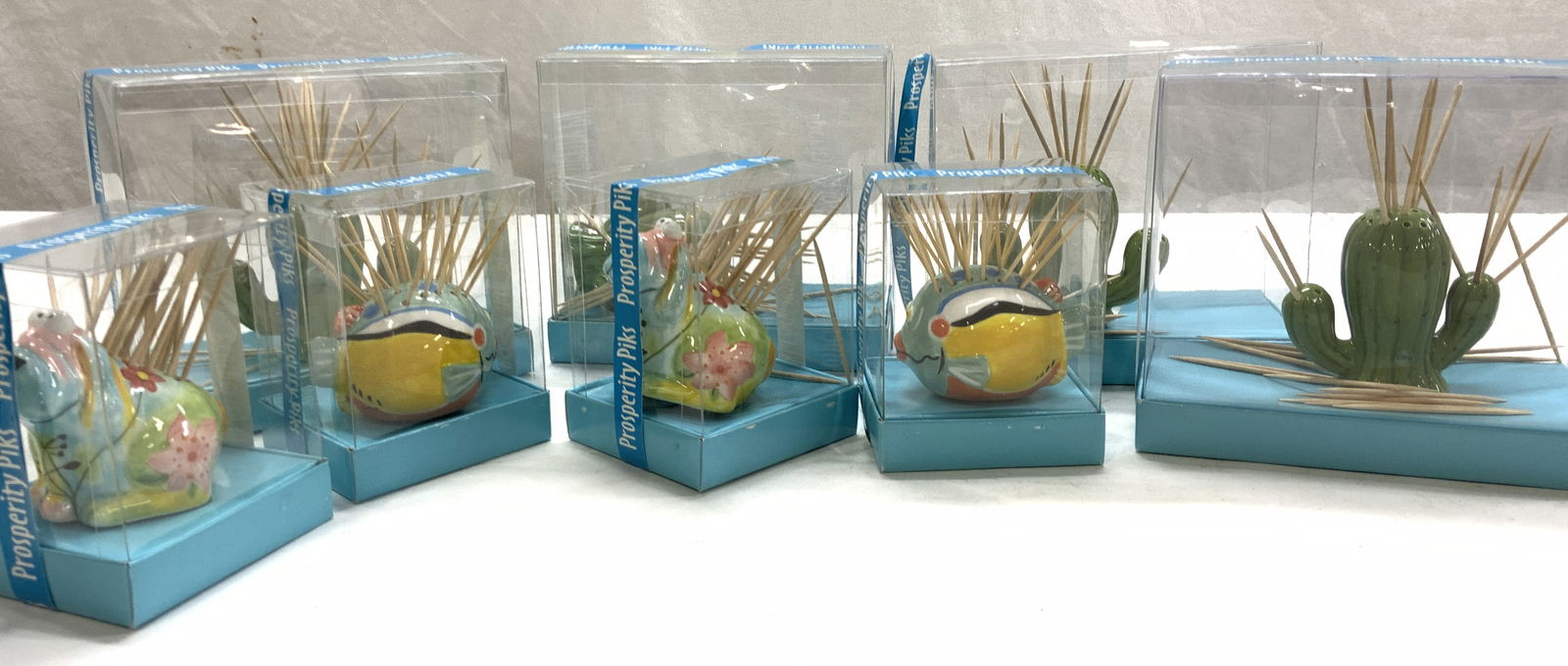8 NIB Prosperity Piks Porcelain Novelty Holders: Porcelain Novelty Pick holders. Cactus, Fish, and Dog. New in Box. Cast is measures 2.5 in. Tall x 2.5 in. Wide. Novelty Pick Holders, Tableware accessories, Party ware, Appetizer Picks and Holder, De