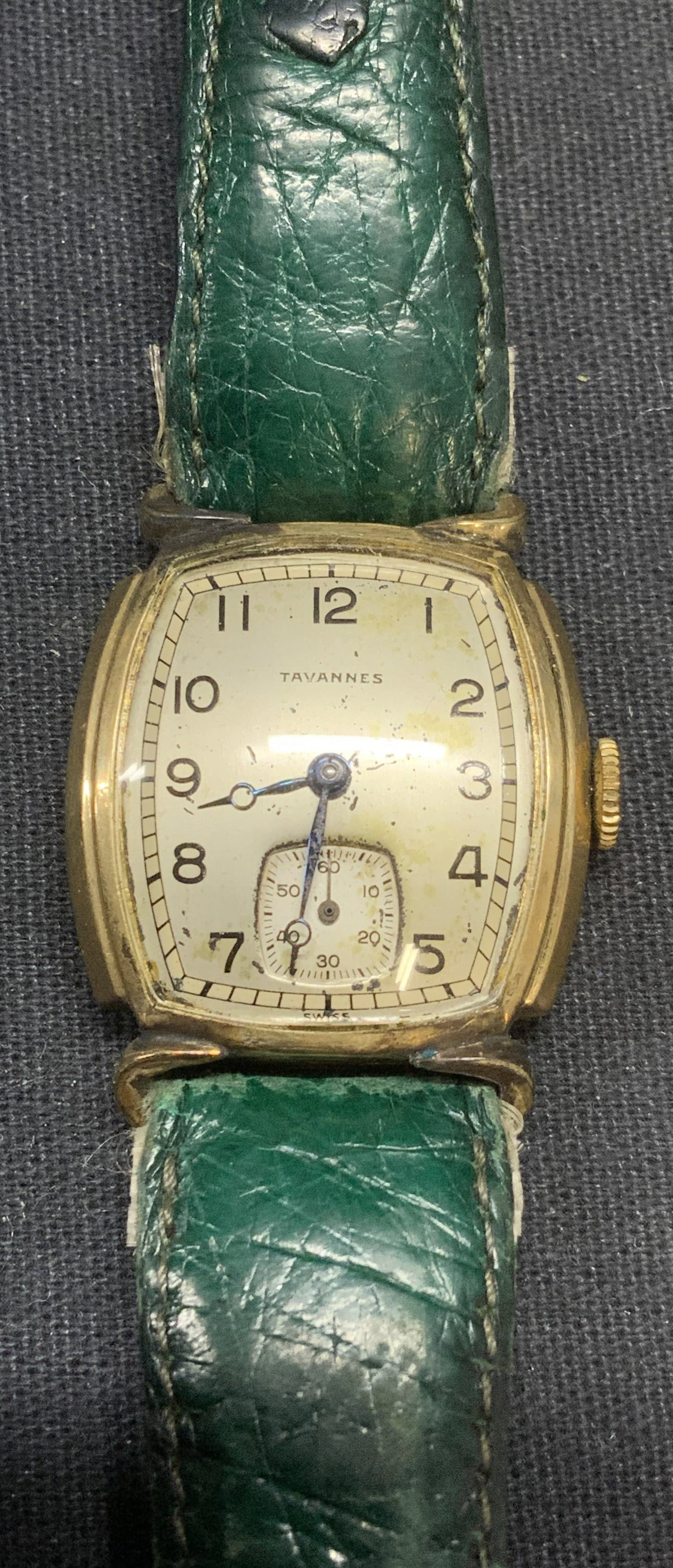 Vtg Tavannes Gold Plated Green Leather Watch: Vintage Tavannes 10k gold plated watch with green leather strap. Signed on face. Marked gold plated. Measures approx. 8 inches long. Not tested for function. Some surface wear including scratching obs