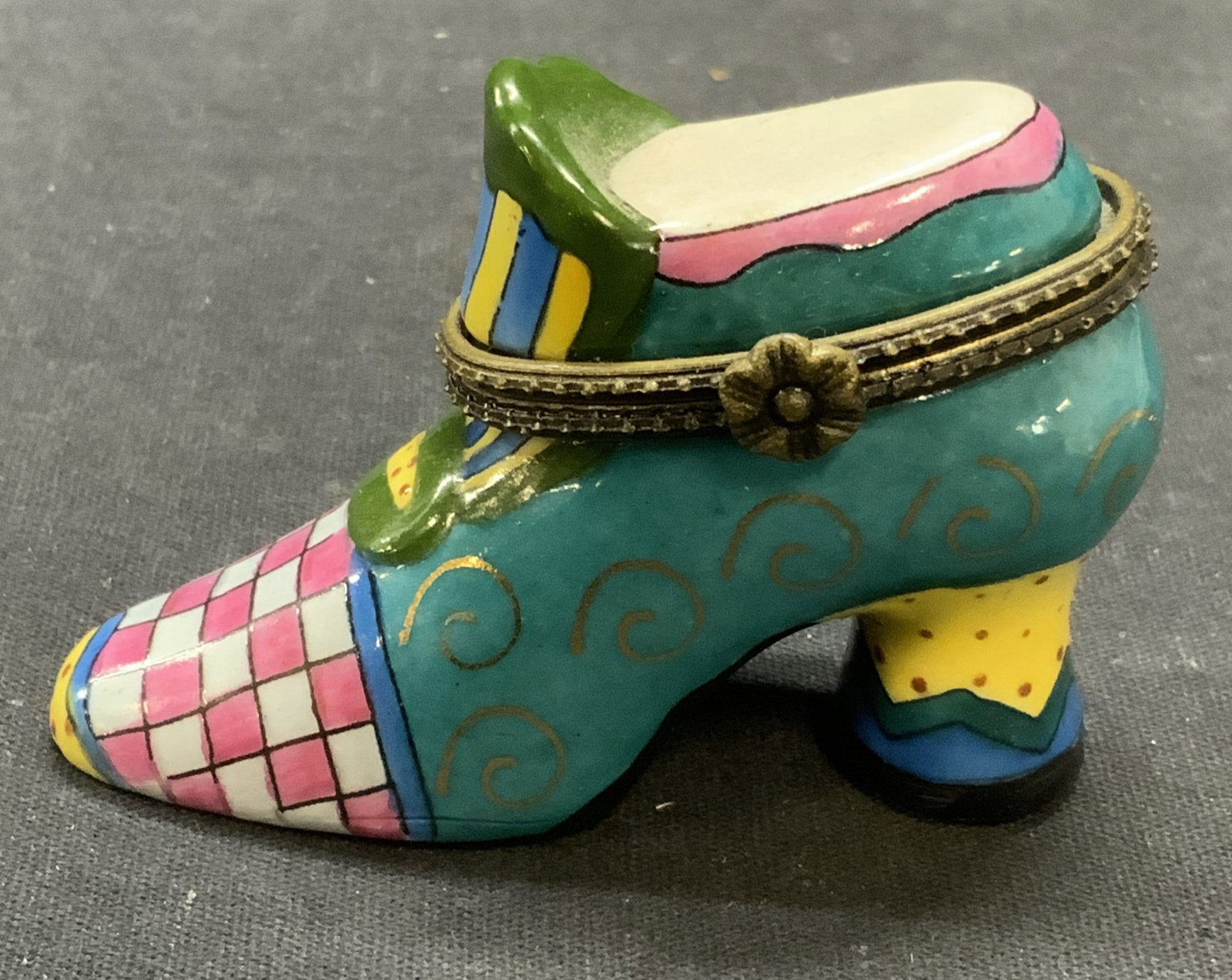Vintage CBK Porcelain Shoe Trinket Box: Vintage 1997 CBK porcelain shoe trinket box. Raised flower clasp. Hand painted multi color with gilt decoration. Trademarked to underside. Measures approx. 2.75 x 1.25 x 1.75 inches. Some surface wear