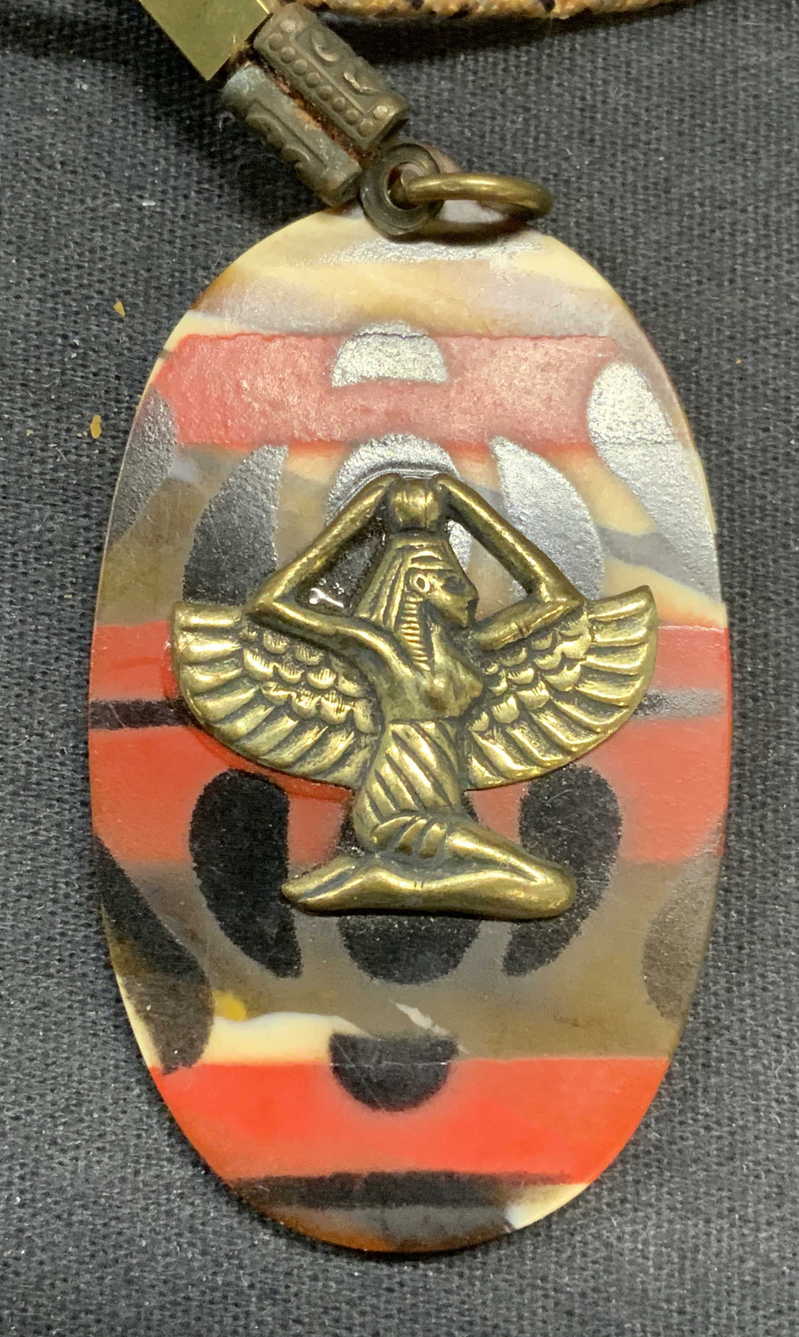 Vintage Egyptian Motif Pendant Necklace: Vintage pendant necklace with acrylic pendant and Egyptian figural motif. Drop length approx. 14 inches. Pendant measures approx. 2.25 x 1.25 inches. Some surface wear including scratching observed. E