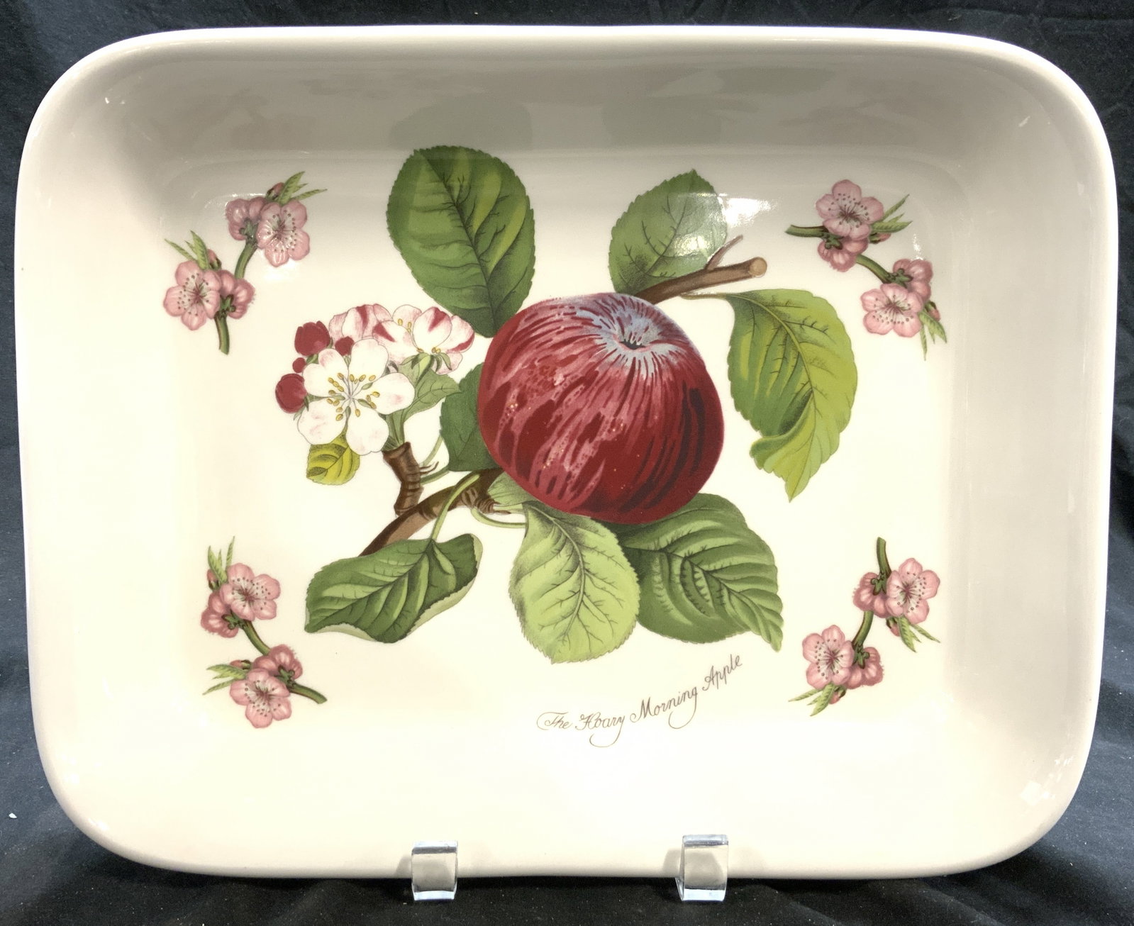 POMONA PORTMERION Porc Casserole Dish ENGLAND: Underside is marked POMONA PORTMERION MADE IN ENGLAND. Casserole dish is cream toned porcelain with multi toned floral, apple, and leaf detail. Vine & leaf detail to exterior. Piece measures approxima