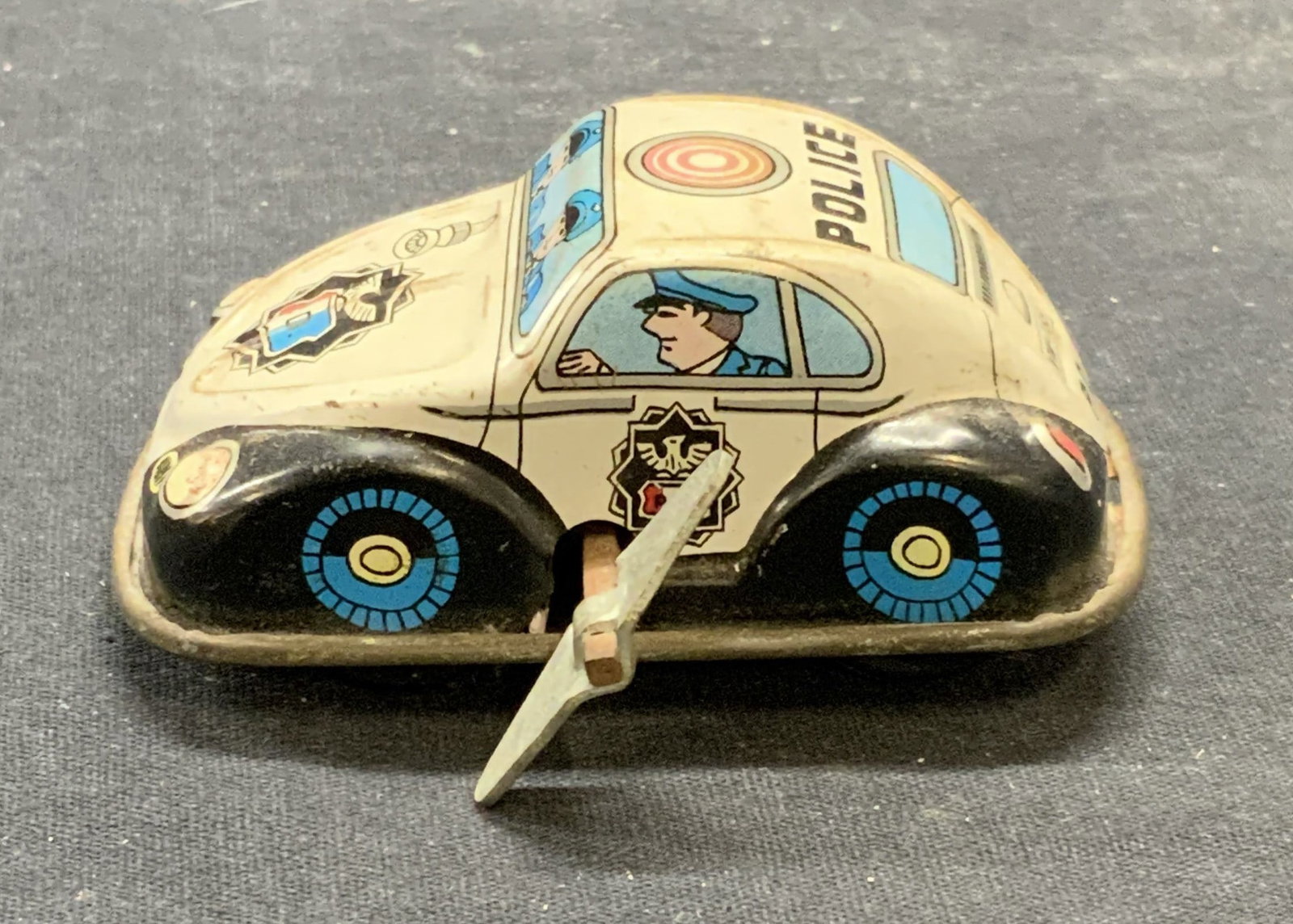 Vintage Police Wind Up Toy Car: Vintage Police wind up toy car. Enameled Metal. Measures approx. 3 x 2 x 1 inches. Not tested for function. Some surface wear including scratching observed. Police, police car, toy car, vintage toy ca