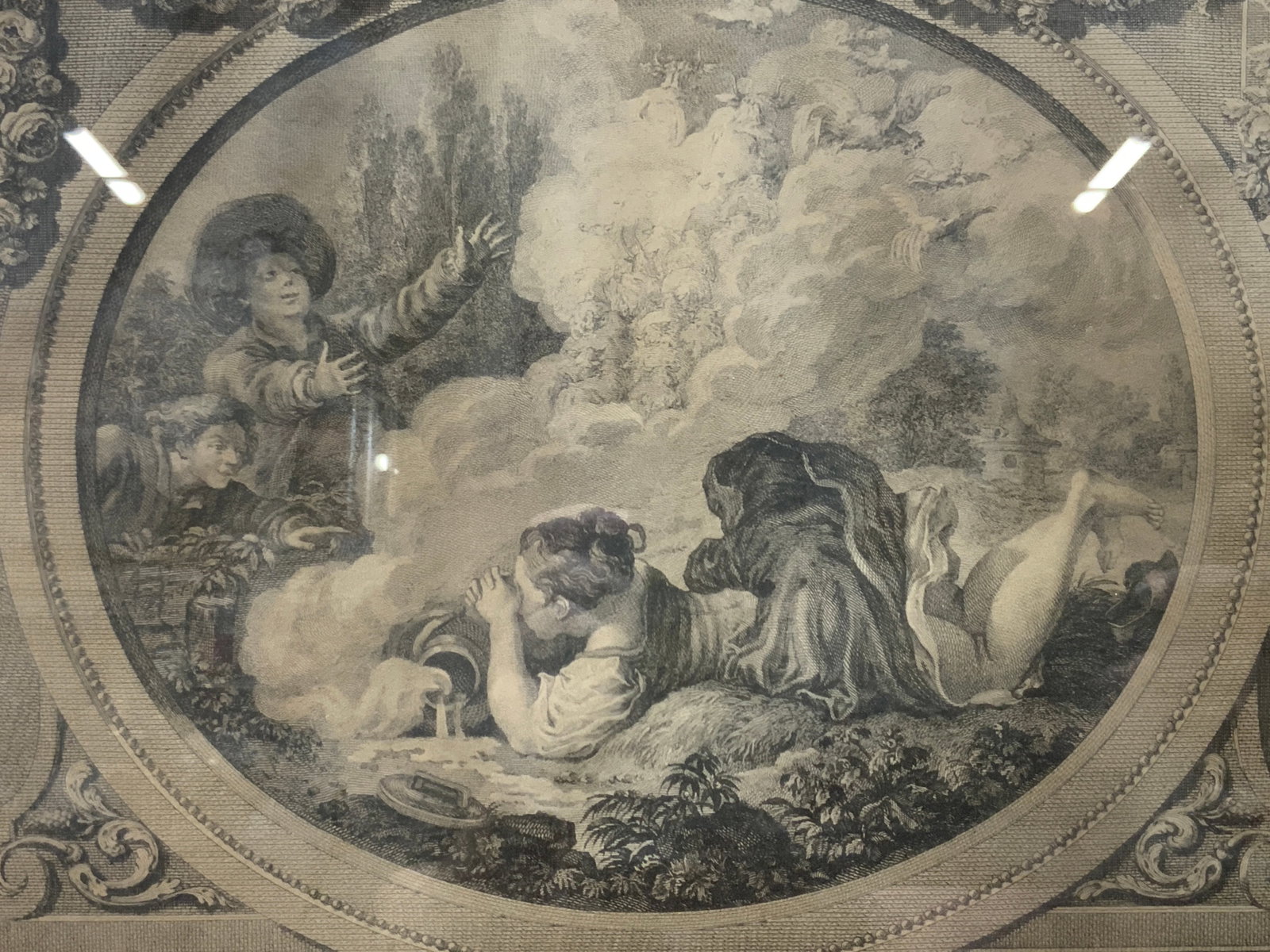 Le Pot Au Lait Etching: Etching marketing Le Pot and Au Lait, depicts a woman dumping a pot into a waterway creating steam and children interested in the clouds. Framed in a gold leafed wooden frame with gray toned mat board