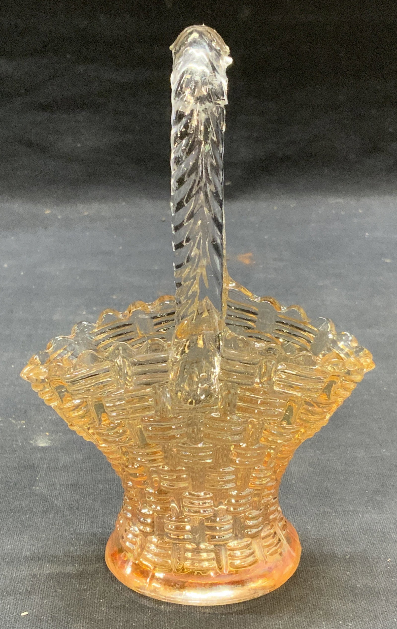 Clear to Orange Art Glass Basket: Clear to orange Art glass basket with embossed raised surface. Measures approx. 3.75 x 2.25 x 5.75 inches. Some surface wear including scratching observed. Small crack on handle observed. Art glass, a