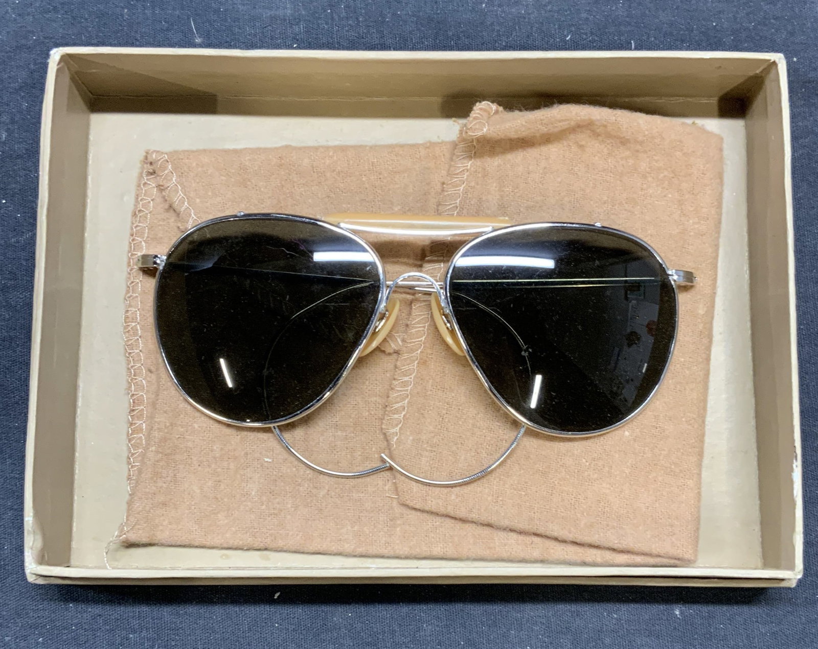 Silver & Tan Toned Aviator Sunglasses: Silver and tan toned aviator sunglasses. Includes Louis Vuitton pouch and box. Sunglasses measure approx. 5.25 x 4.25 inches. Some surface wear including scratching observed. Sunglasses, aviator sungl