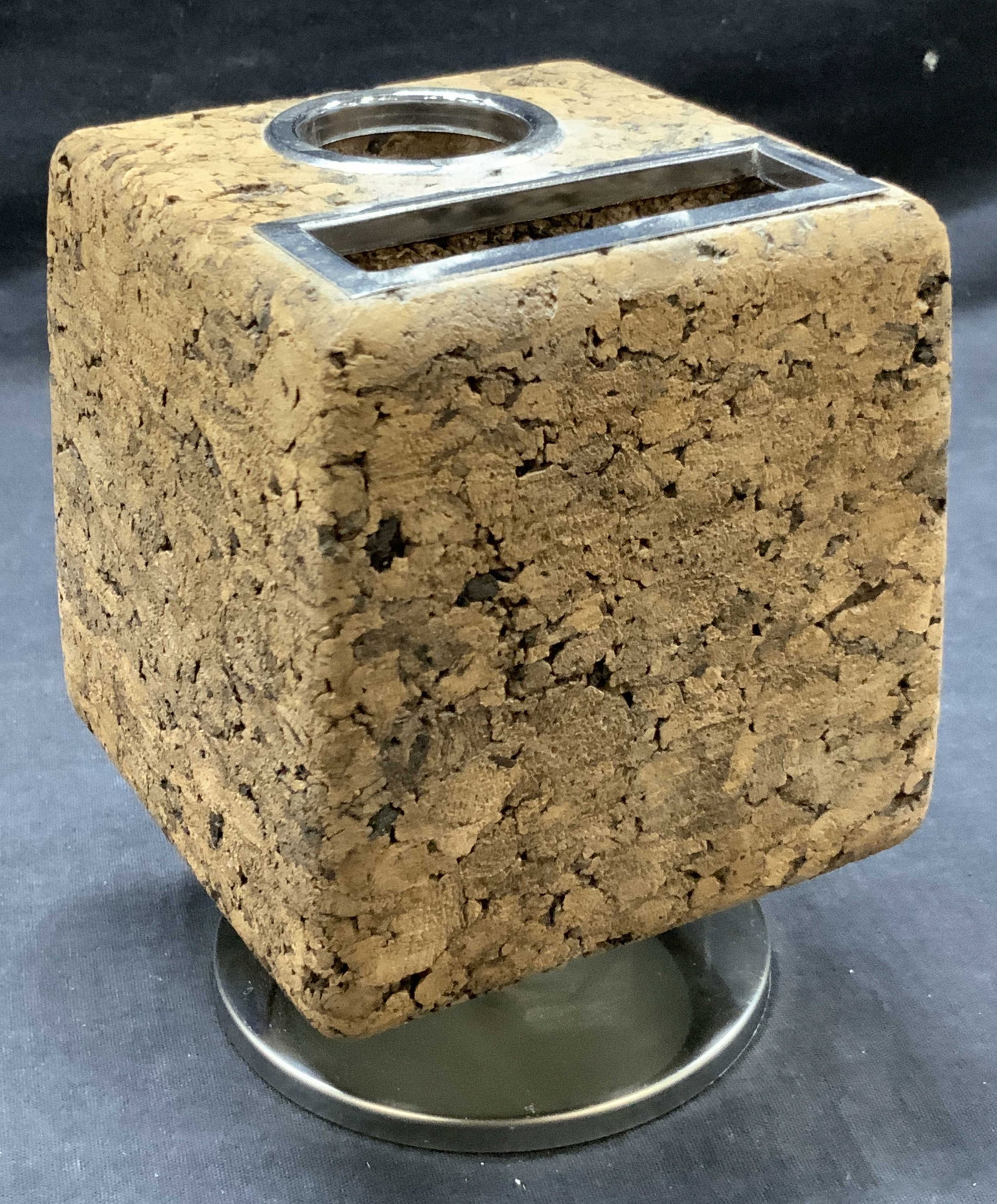 Vgt Footed Cork Desk Organizer: Vintage cork block desk organizer made of a block of cork with cut out sections and with a chrome toned metal footing. Approx 4 x 4 inches wide and 6 inches tall Moderate wearing to footing and to the