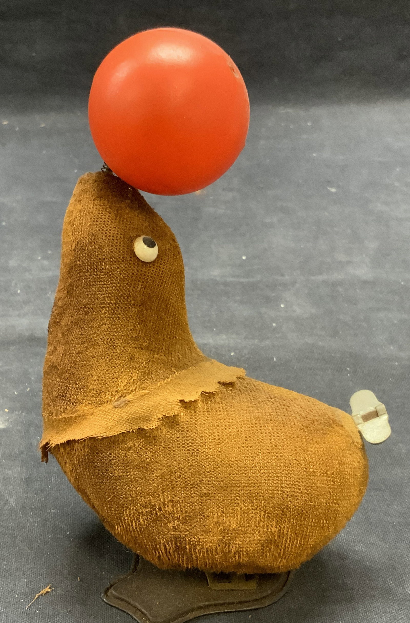 Vintage Seal & Ball Wind Up Toy: Vintage seal and ball motif wind up toy. Fabric, plastic, and metal. Measures approx. 4 x 2 x 6.25 inches. Wear to material consistent with exposure. Not tested for function. Toy, vintage toy, wind up