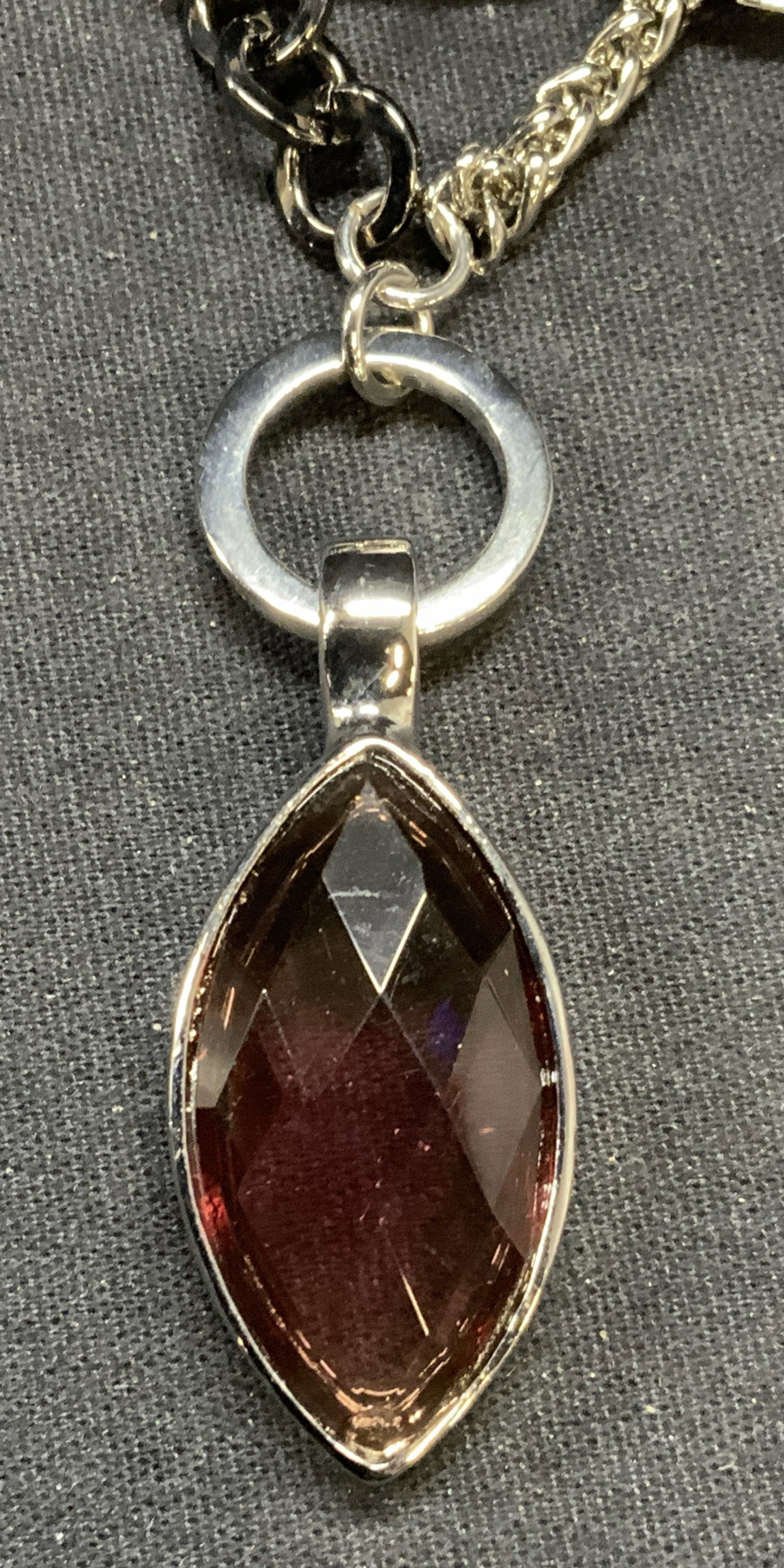 AK Silver Tone Purple Crystal Pendant Necklace NWT: AK silver tone necklace with purple crystal pendant. New with tag. Drop length approx. 16 inches. Pendant length approx. 2.25 inches. Some surface wear including scratching observed. Estate jewelry, c