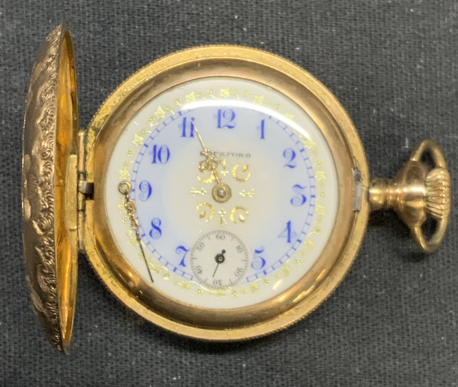 Vtg Rockford Watch Co Gold Filled Pocket Watch: Vintage Rockford Watch Co gold filled pocket watch. Gilt face. Signed on face. Etched scroll vase. Measures approx. 1.5 inches diameter. Not tested for function. Some surface wear including scratching