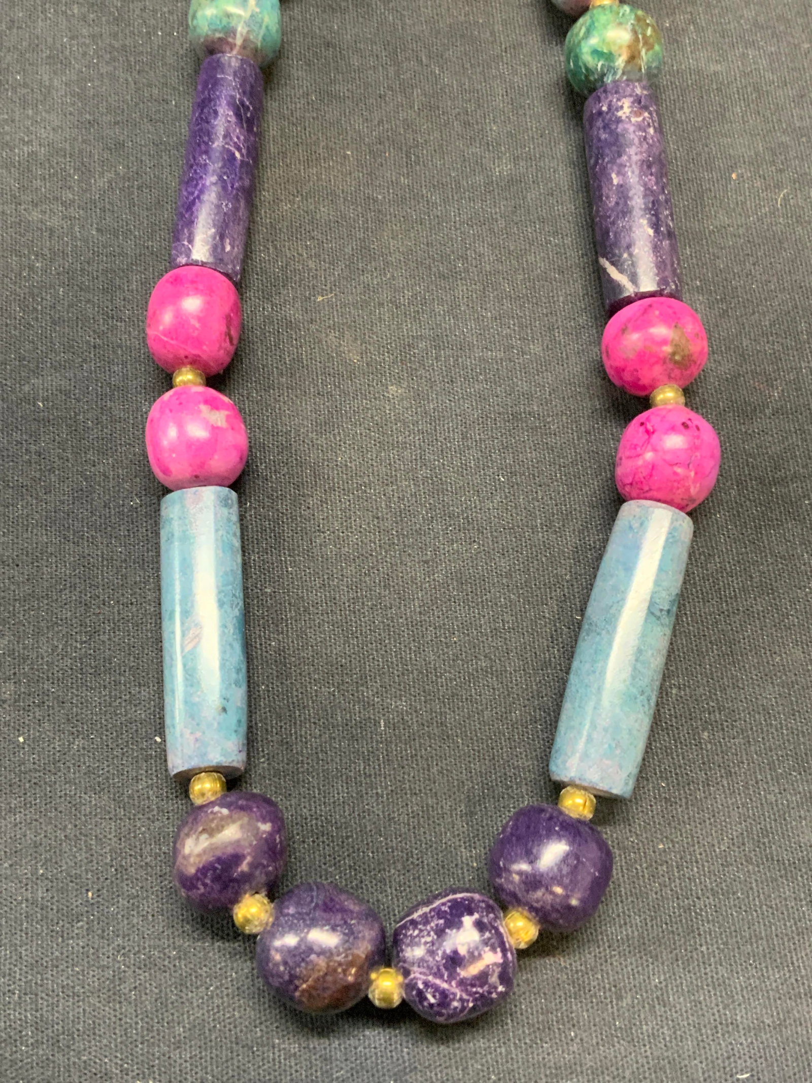 Purple & Blue Beaded Ceramic Necklace: Purple, blue, and pink toned beaded ceramic necklace. Drop length approx. 10.5 inches. Some surface wear including scratching observed. Estate jewelry, costume jewelry, cocktail jewelry, fashion jewel
