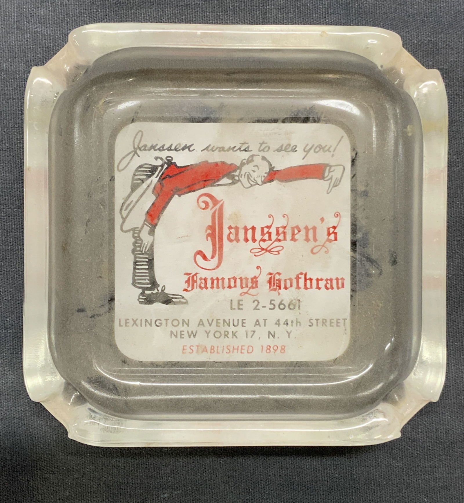 Vtg Janssens Restaurant Glass Ashtray: Vintage Janssens restaurant glass ashtray. Graphic print on base. Measures approx. 4 x 4 x 1 inches. Some surface wear including scratching observed. Ashtray, restaurant ashtray, vintage ashtray, glas