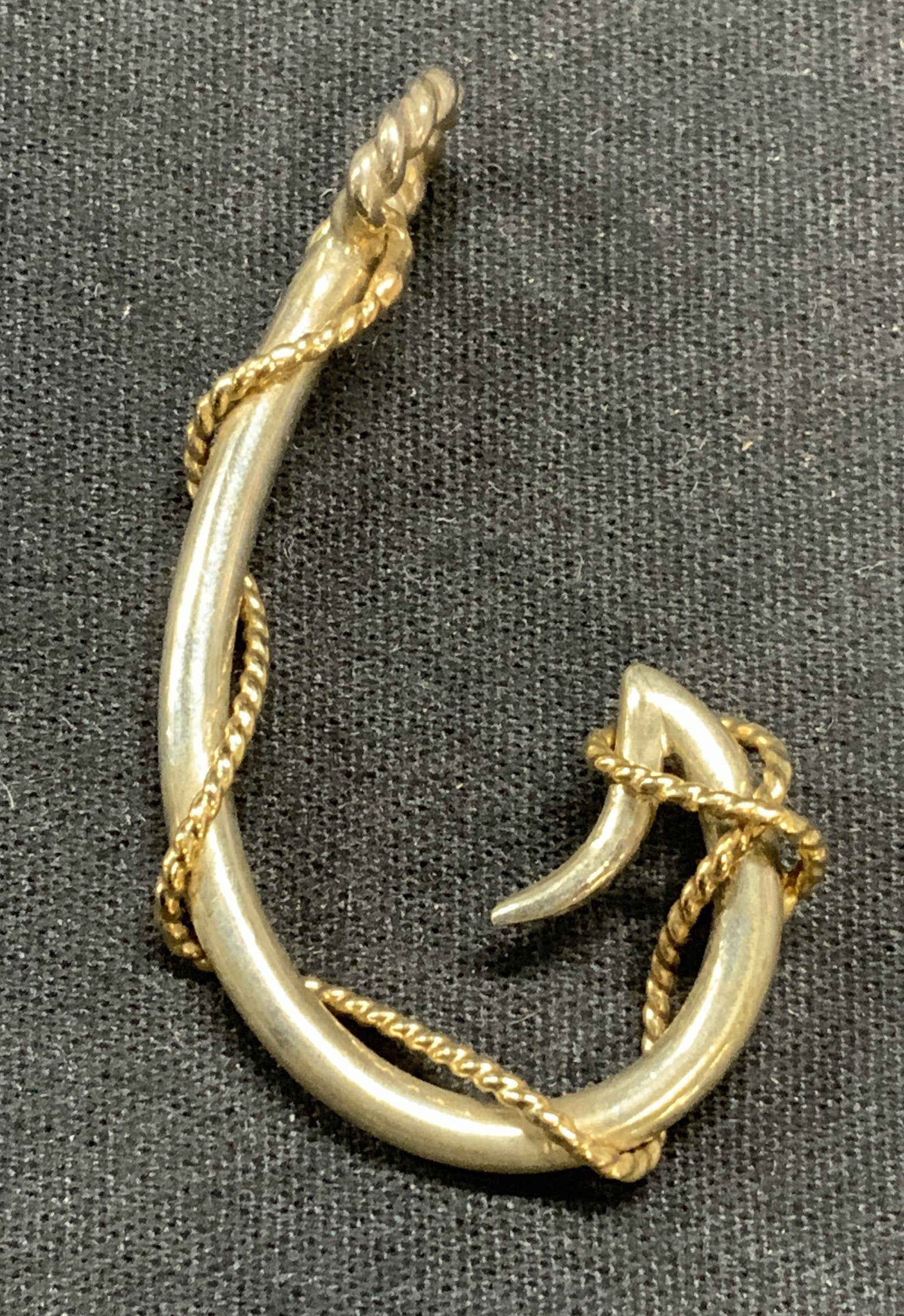 Sterling Silver & Gold Pl Hook Pendant: Sterling silver and gold plated hook pendant with embossed cable motif. Measures approx. 2 x 1 inches. Total weight 9.8 grams. Tests for sterling using PuriTEST kit. Some surface wear including scratc