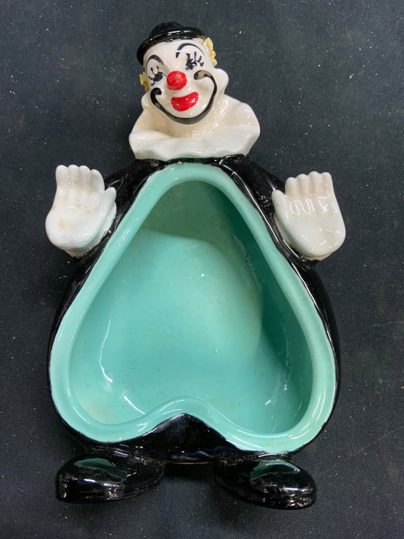 LEFTONS Porcelain Clown Trinket Dish Vessel Japan: Tag reads LEFTONS JAPAN. Piece is porcelain. Dish has clown form. Piece appears to be hand painted. Interior is seafoam green toned. Piece measures approximately 7 inches tall 4.75 inches wide. 2.25 i