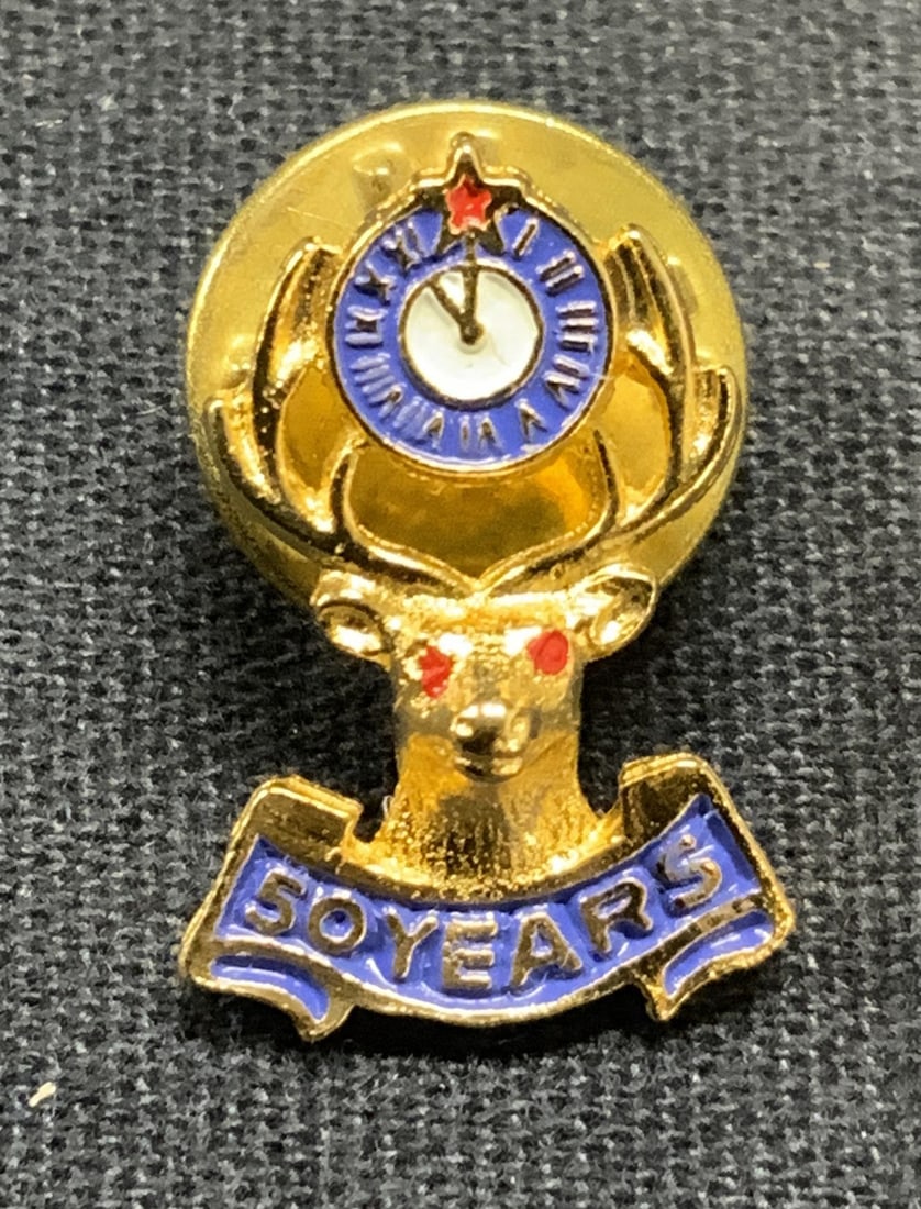 Gold Tone Enameled Deer Head 50 Year Pin: Gold tone enameled deer head and clock motif pin. Reads 50 Years. Measures approx. .75 inches long. Some surface wear including scratching observed. Estate jewelry, costume jewelry, cocktail jewelry, 