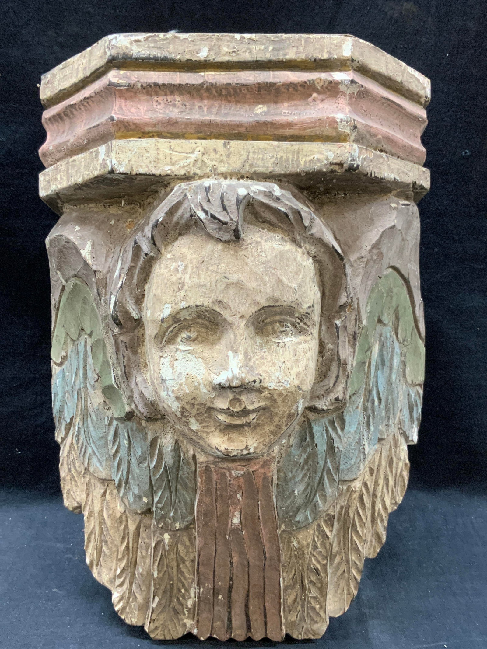 Vtg Carved Cherub Head Wooden Wall Accessory: Vintage carved wooden wall Accessory with a cherub head with blue green and red painted wings flanking the head. Approx 13 inches tall and 9 inches wide Moderate weight. Evident losses and wearing to 