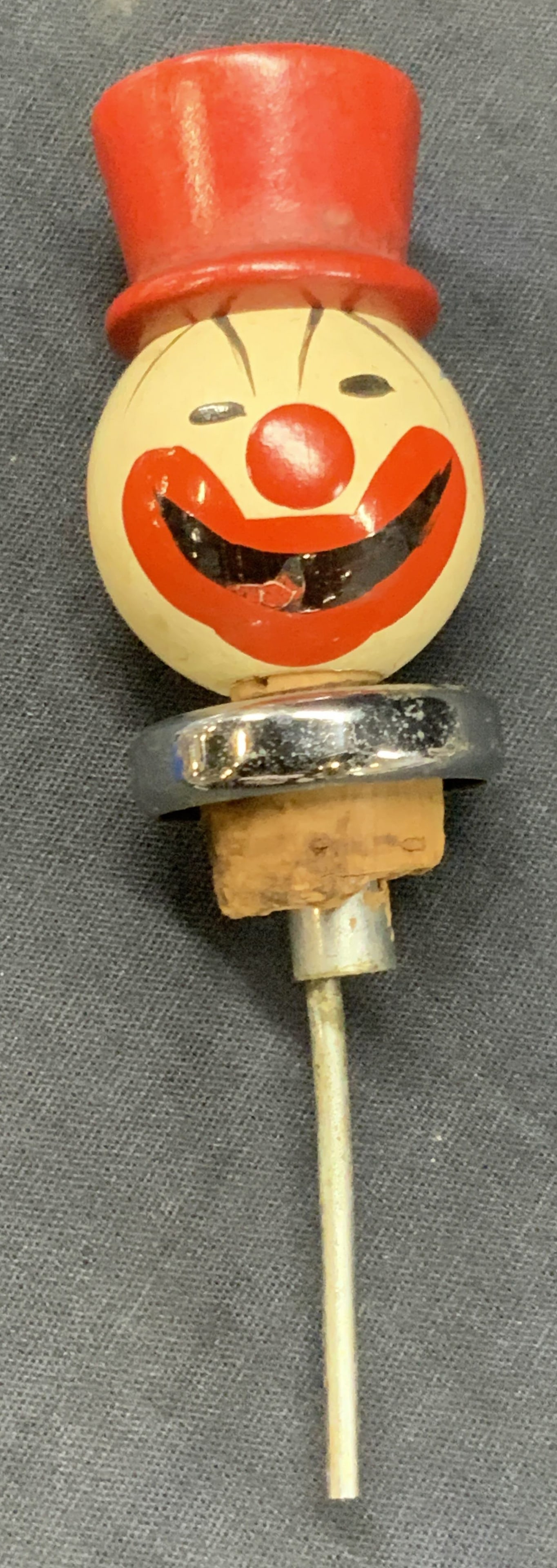 Vtg Hand Painted Wooden Clown Wine Bottle Cork: Vintage hand painted wooden wine bottle cork resembling a clown with a red painted face and red to hat and cork stopper. Approx 5 inches long and 1.5 inches wide. Moderate wearing to paint and wood an