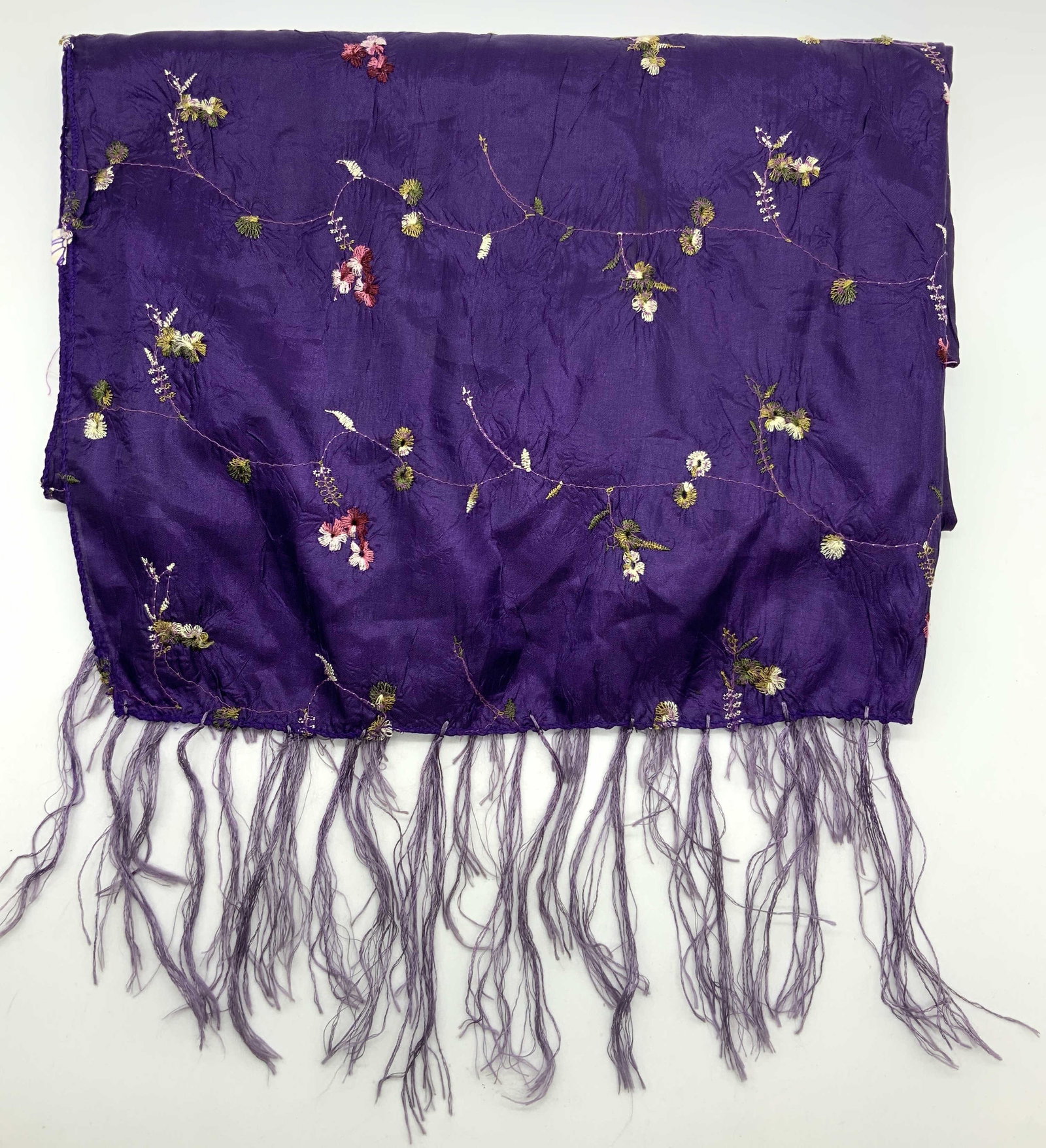 Silk Embroidered Floral Fringe Scarf: Purple toned, possibly silk fringed scarf with embroidered flowers in green and pink. Approx 25 x 60 inches Moderate wearing to threading throughout with pulled threading Vintage scarf, scarf. Silk sc