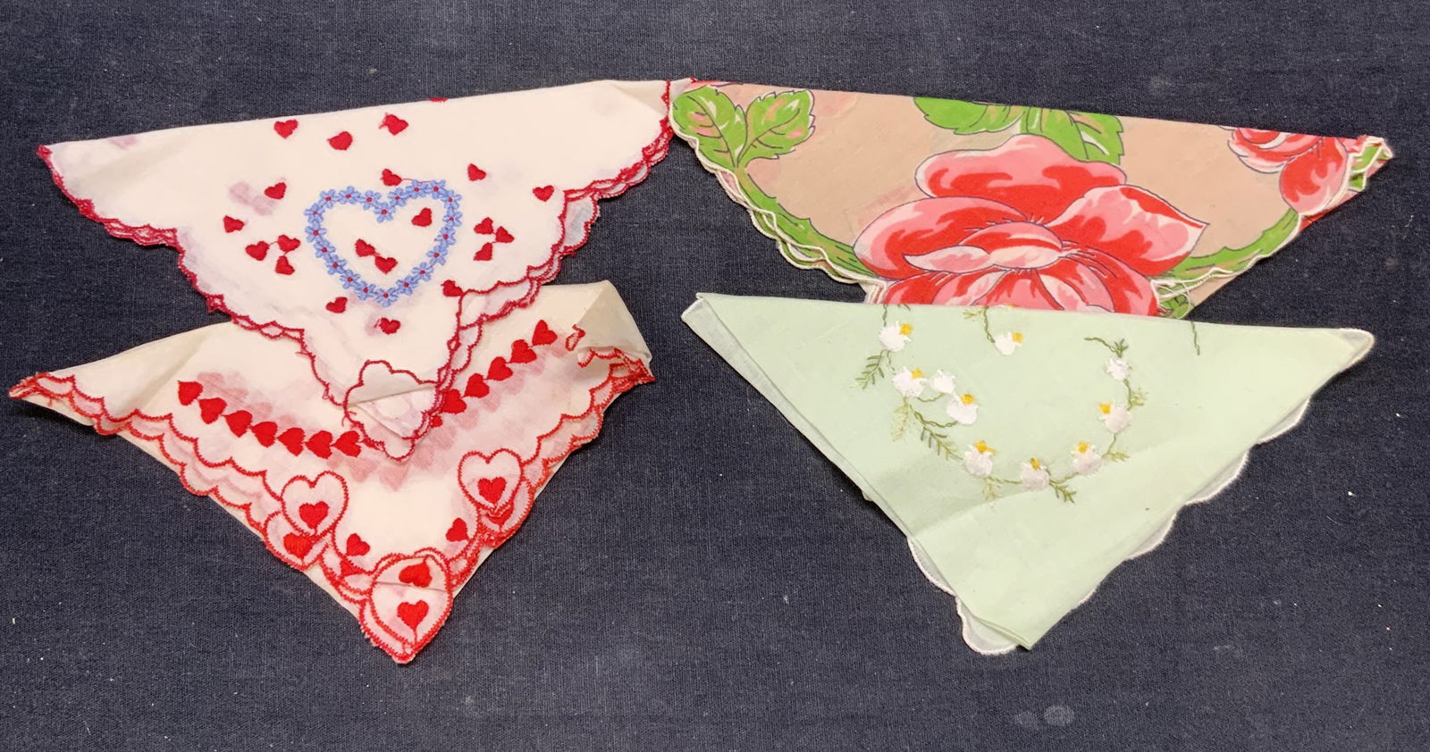 Lot 4 Vintage Flower & Heart Cotton Handkerchiefs: Lot of 4 vintage cotton handkerchief with embroidered and printed flower and heart motifs. Largest handkerchief measures approx. 12 x 12 inches. All pieces have some wear to material consistent with e