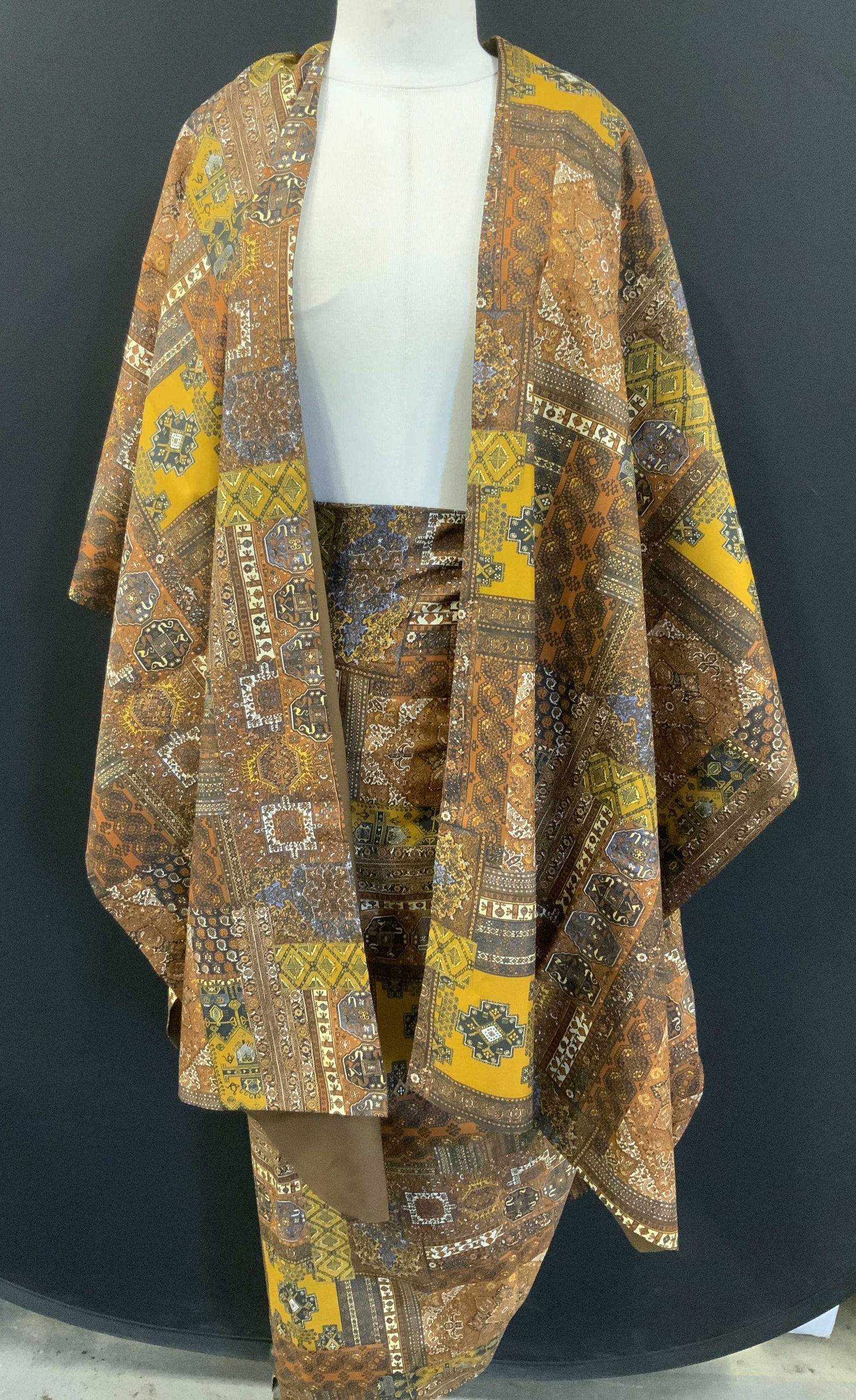 Handmade Multi Print Cape & Wrap Skirt, 2: East Asian multi print cape and tie skirt. Cape drops 36 in. and 31 in. Front / Back. One size fits most., 22 in. Wide. Skirt ties at waist , 63 in. waist, 41 in. Long. Fabric possibly polyester or ra