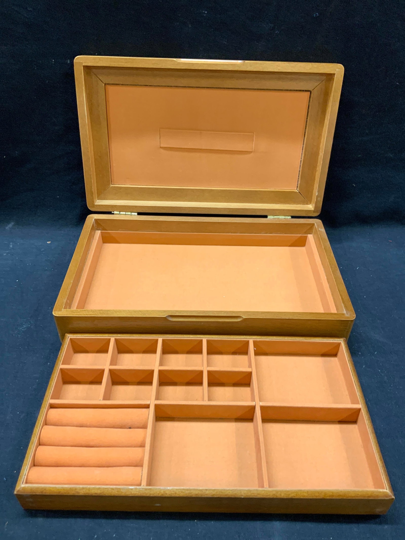 Vtg Wooden Jewelry Box: Vintage tan toned wooden jewelry box with Inlayed wooden design on lid, interior is lined with orange toned velvet with ring sections and removable top section to box. Approx 7 x 12 x 3 inches Moderat