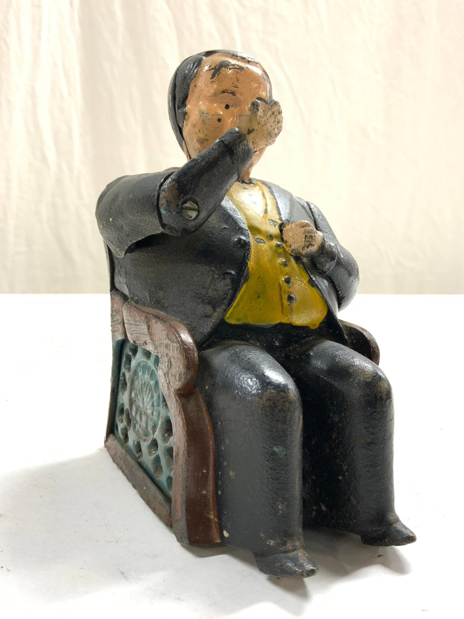 Antq Tammany Iron Mechanical Coin Bank: Coin bank appears to be antique, possibly vintage. Coin bank is iron. Piece depicts a seated male figure wearing a tuxedo. Coin back appears to be hand painted. Piece measures approximately 5.5 3.5 in