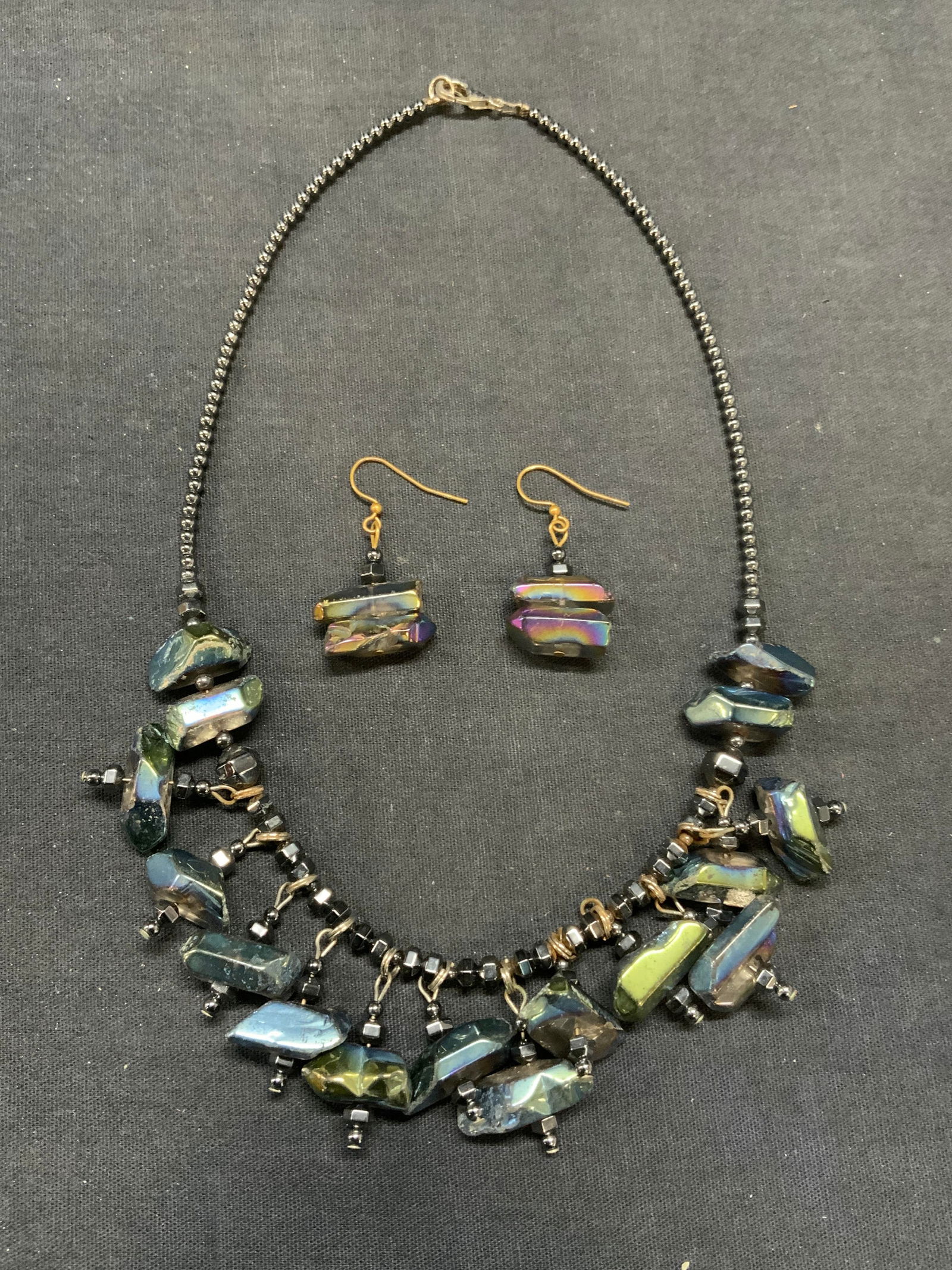 2 Rainbow Aura Stone Necklace & Earrings: 2 matching rainbow aura stone beaded choker necklace and dangle earrings. Possibly titanium Quartz. Necklace drop length approx. 8 inches. Earrings measure approx. 1 inches long. Some surface wear inc