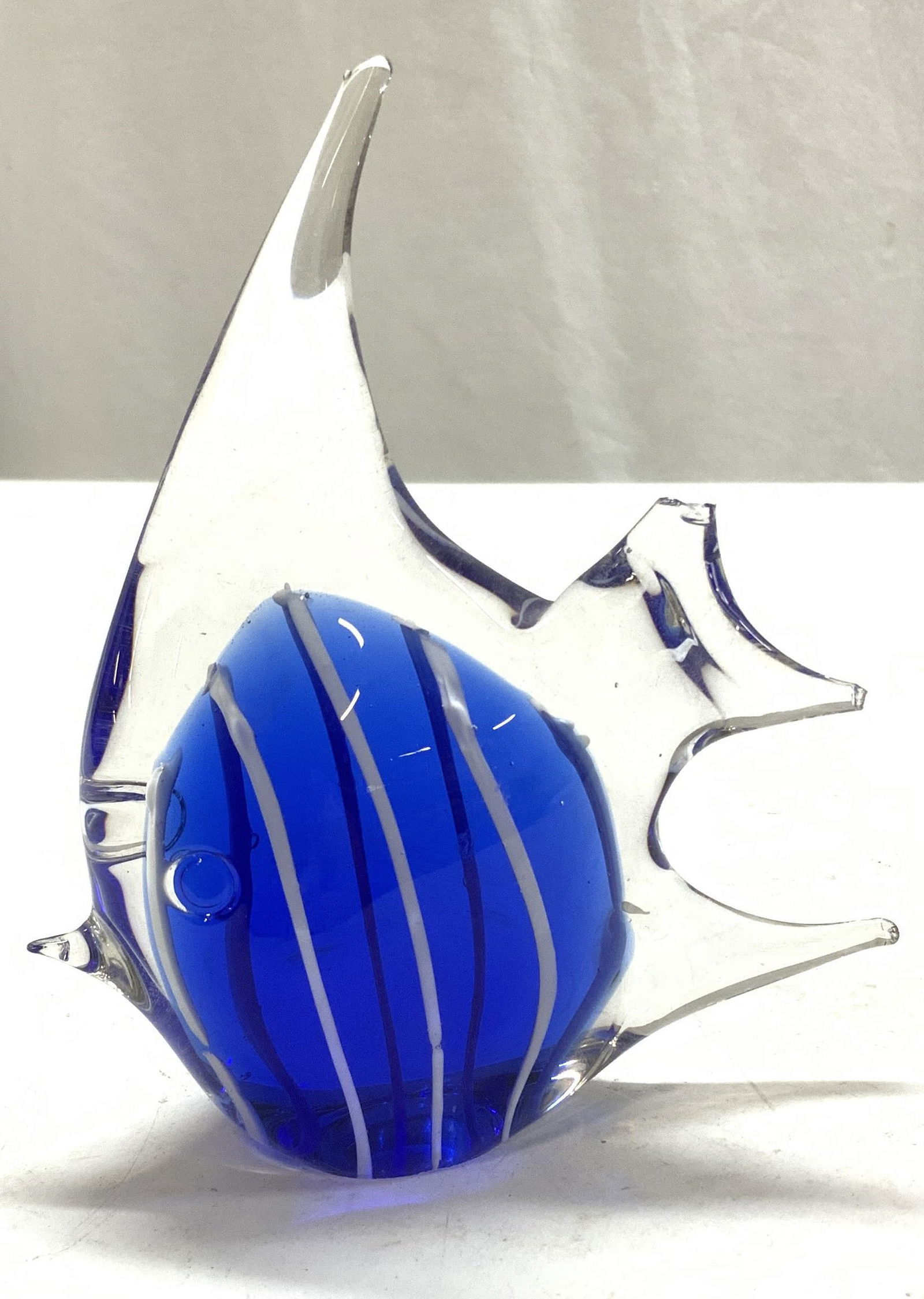 Art Glass Angle Fish Figural: Cobalt blue fish figural/paperweight. Blown Art glass. Tip chips to center fins. Measures 5.25 in ht. X 4.75 in. Long. Decorative arts, art glass fish paperweight, desk accessories, blown glass fish,