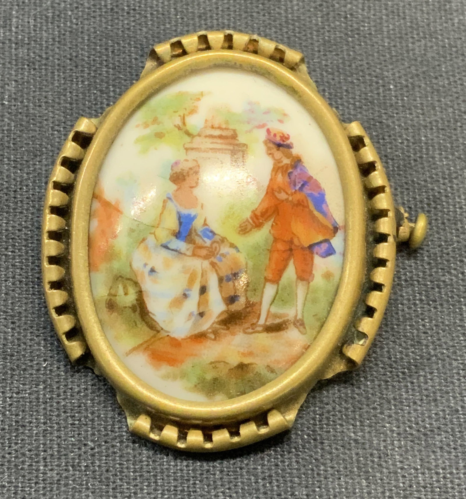 Vtg Limoges Porcelain Figural Brooch, France: Vintage Limoges porcelain and brass brooch. Hand painted figural motif. Signed to underside. Made in France. Measures approx. 1.5 x 1.25 inches. Some surface wear including scratching observed. Estate