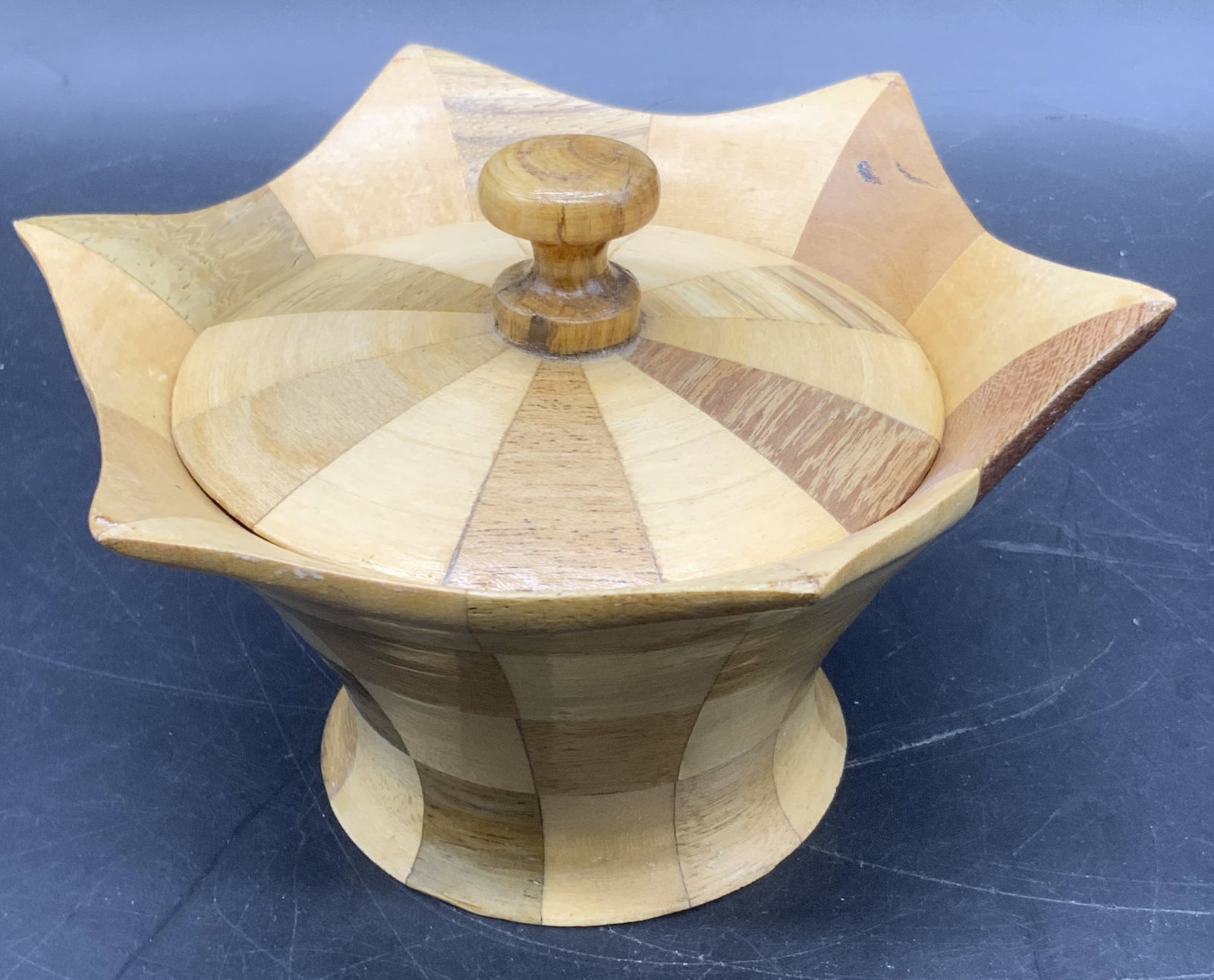 BURRITT POND Handcrafted Lidded Trinket Box: A handcrafted lidded trinket box. Inlaid woodwork throughout comprised of various brown hues. Measures approx. 3H x 5.75W in. Underside marked BY BURRITT POND. Some wear consistent with age, use, and 