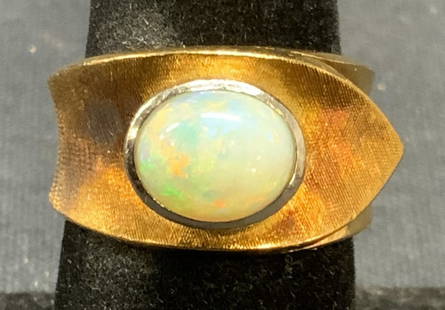 14k Gold & Opal Statement Ring: 14k gold statement ring with brushed detail on band and Opal gemstone. Marked 525. Ring size 6. Total weight 13.1 grams. Some surface wear including scratching observed. Estate jewelry, fine
