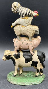 MIDWEST IMPORTERS Stacked Farm Animals Doorstop: A painted cast iron stacked farm animal doorstep. Animals include a pig, sheep, duck, cow, and chicken. Sticker to reverse reads MIDWEST IMPORTERS. Measures approx. 9H x 5.25W in. Some losses to