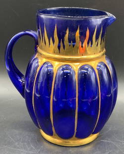 EUROGLASS Hand Blown Cobalt Glass Pitcher, Italy: Hand Blown Cobalt Blue Italian Euro Glass Pitcher. Applied handle. Spouted. Gilt accents. Sticker to underside reads EUROGLASS, MADE IN ITALY. Measures approx. 8H x 7W in. Measurement includes