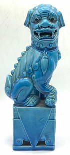Asian Blue Tn Ceramic Fu Dog Figural: Asian fu dog figure of a female fu dog, represented with cub under its paw. Blue toned and presented seated on a pedestal Approx 12 inches tall and 2 x 3.5 inch wide base Moderate wearing to