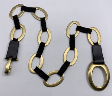 SUZI ROHER Leather & Brass Tn Metal Belt, 2: Heavy gold tone stretch belt with oval brass tone links connected with a black stretch elastic band. Signed plaque SUZI ROHER on leather. Hook and loop closure. SUZI ROHER Dust bag included.