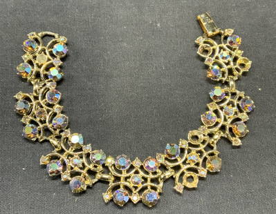Vtg Silver Tone Aurora Borealis Crystal Bracelet: Vintage silver tone bracelet with Aurora borealis crystal decoration. Measures approx. 7 inches long. Some surface wear including scratching observed. Some crystals need replacement. Estate